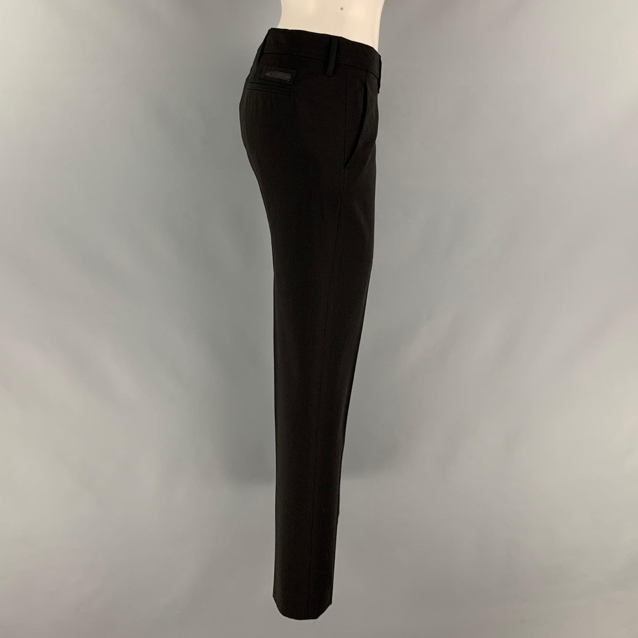 PRADA dress pants comes in a black polyester and viscose material featuring a straight style, front tab, and a zip fly closure. Made in Italy.Good Pre-Owned Condition. Moderate Signs of Wear. As- Is. 

Marked:  44 

Measurements: 
 Waist: 34 inches