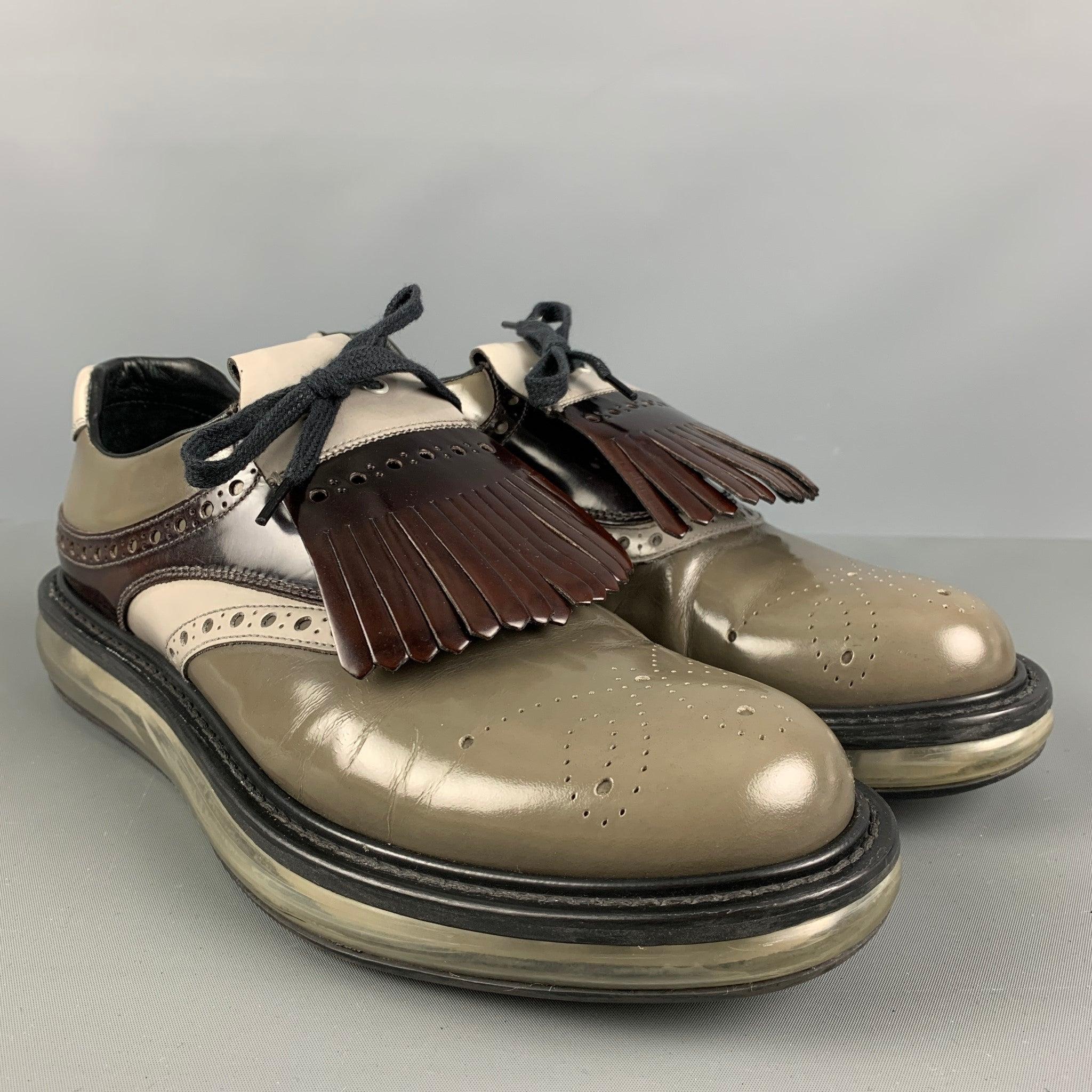 PRADA shoes comes in a brown and grey perforated leather featuring a transparent sole, detachable apron and a lace up closure. Very Good Pre-Owned Condition. 

Marked:   2 EE 100 7 Outsole: 12.5 inches  x 4.5 inches 
  
  
 
Reference: