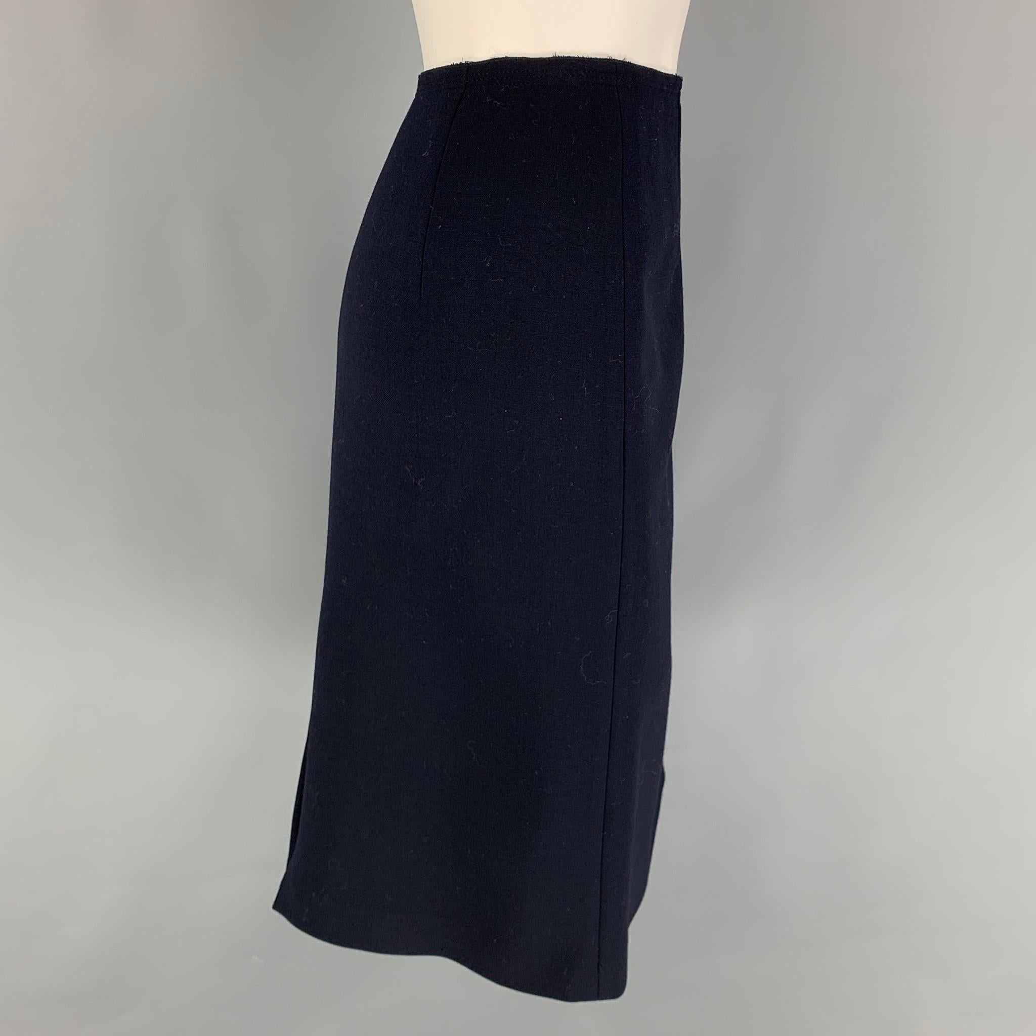 PRADA skirt comes in a navy wool featuring a pencil style, back slit, and a side zipper closure. Made in Italy. 

Very Good Pre-Owned Condition.
Marked: 44

Measurements:

Waist: 30 in.
Hip: 36 in.
Length: 24.5 in. 