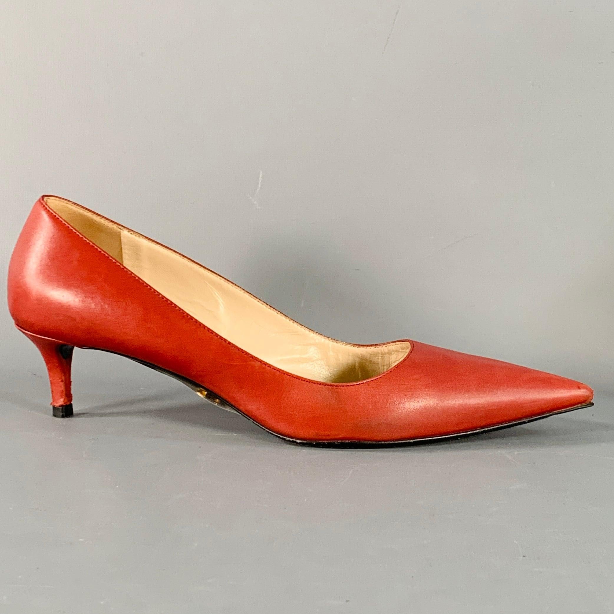 PRADA pumps
in a red leather featuring pointed toe and kitten heel. Comes with box. Made in Italy.Good Pre-Owned Condition. Moderate signs of wear sole, some scuffing on toes and heels. 

Marked:   IT 38 

Measurements: 
  Heel: 2 inches 
  
  
