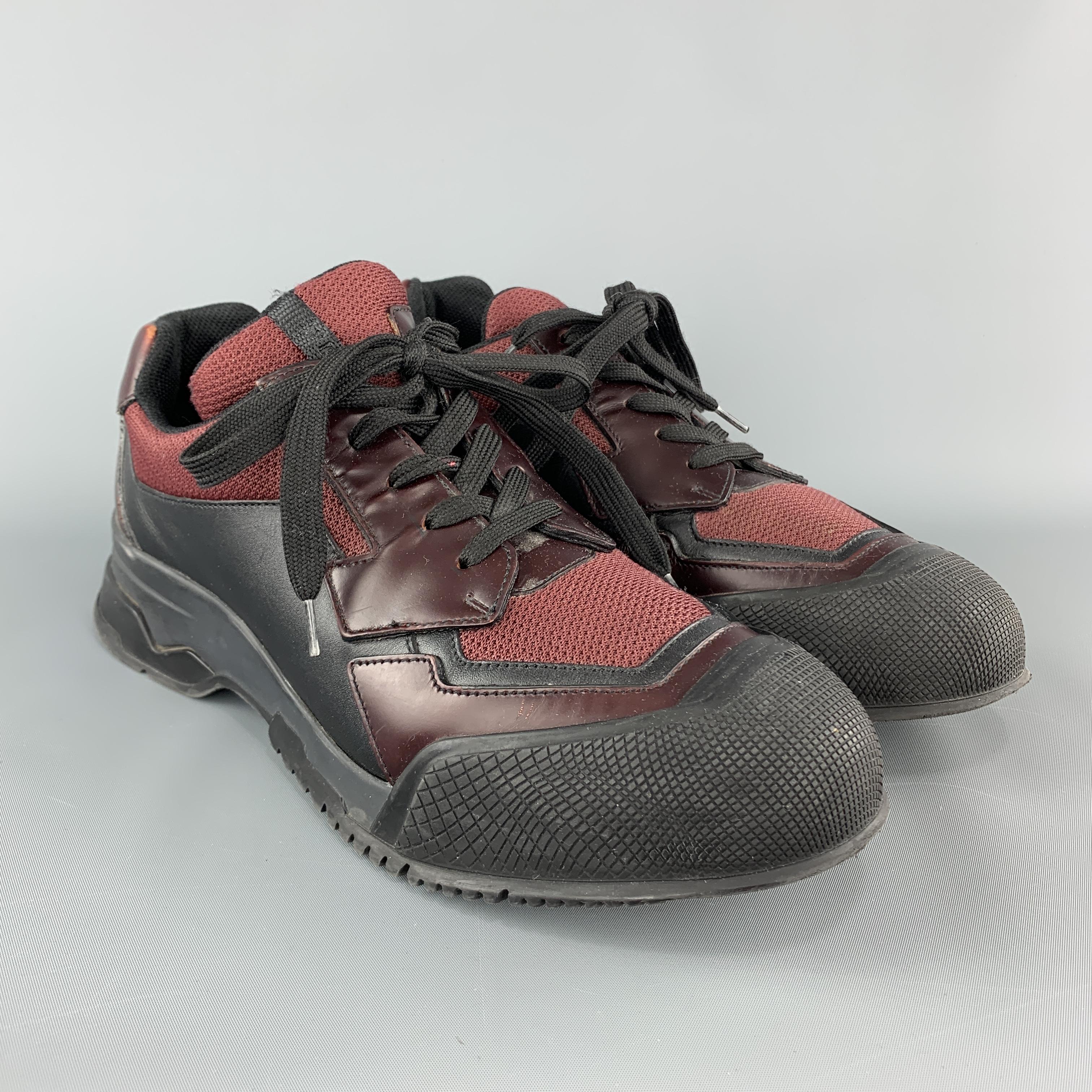 PRADA sneakers come in burgundy mesh with black and burgundy leather panels, and chunky rubber toe cap sole. Made in Italy.

Very Good Pre-Owned Condition.
Marked: UK 7.5

Outsole: 12 x 4.45 in.