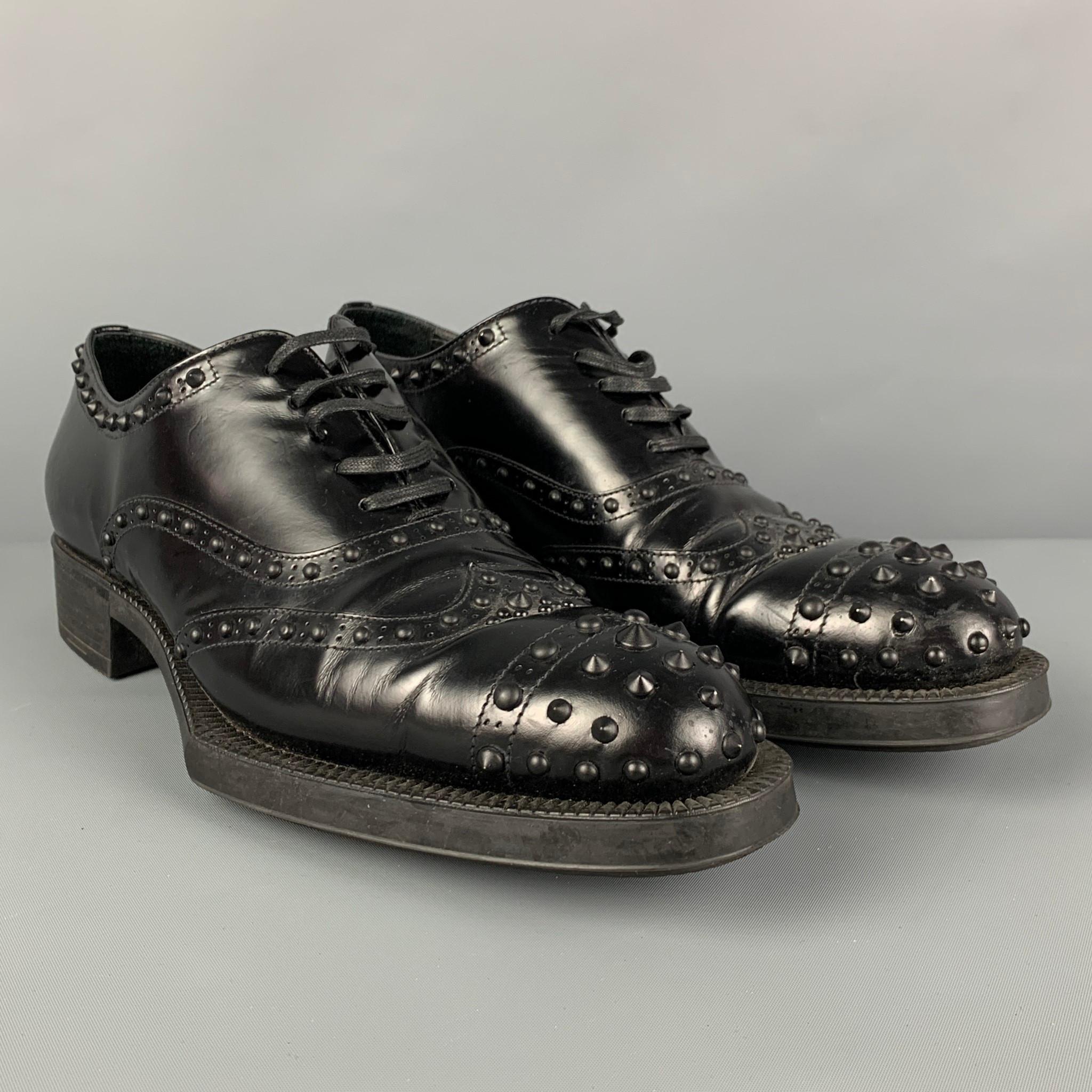 PRADA shoes comes in a black studded leather featuring a cap toe and a lace up closure. Made in Italy.

Very Good Pre-Owned Condition. Minor wear.
Marked: 39

Outsole: 11 in. x 4 in. 