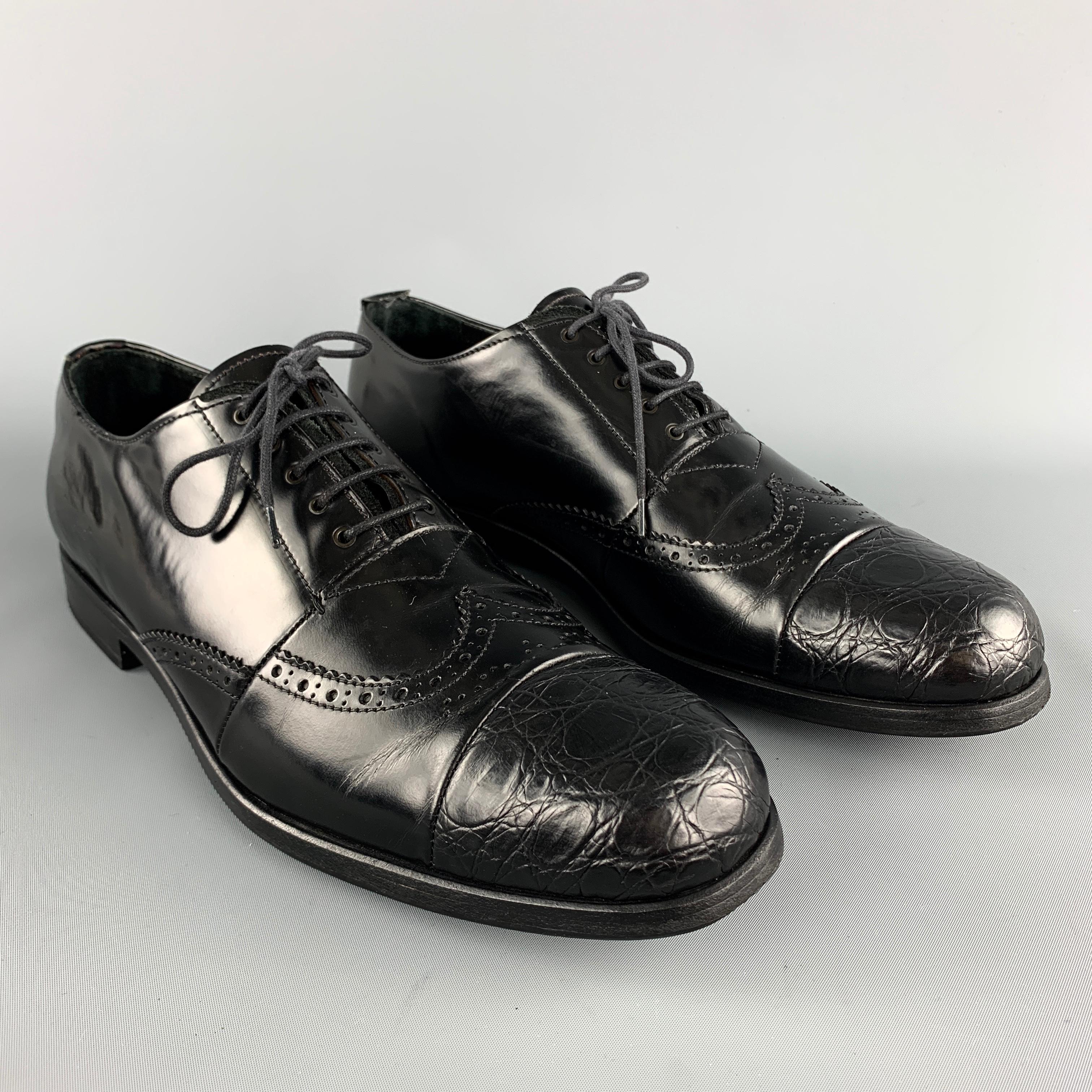 PRADA oxford lace up shoes comes in a black tone in leather material, featuring perforated details, a textured cap toe, a wingtip, and inner and outsole in leather. Made in Italy.

Very Good  Pre-Owned Condition. 
Marked: UK 8  2950 / C    1  2E 