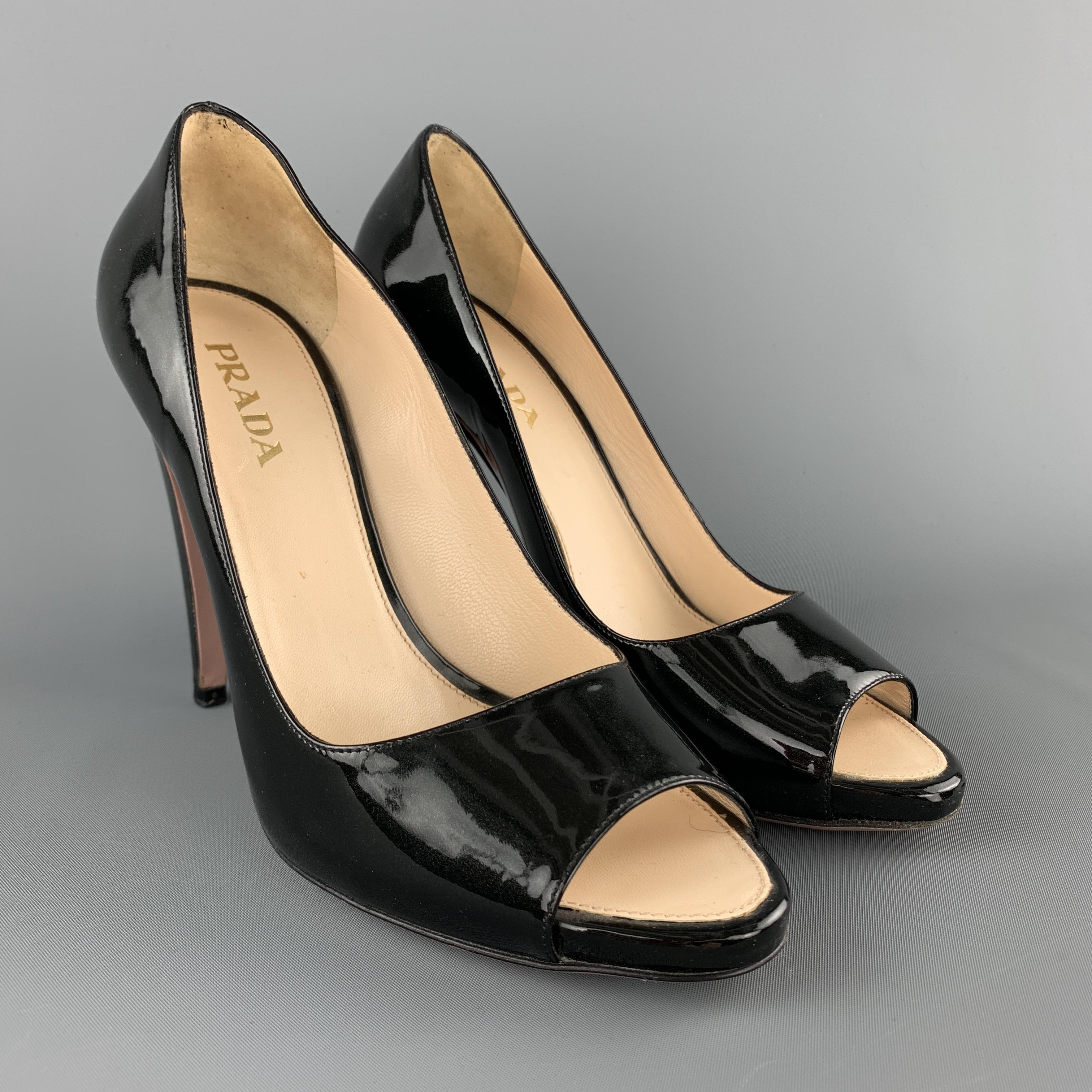 PRADA pumps come in black sparkle patent leather with a peep toe and covered heel. Made in Italy.

Excellent Pre-Owned Condition.
Marked: IT 39 
Original Retail Price: $650.00
 
Measurements:

Heel: 4.5 in.
Platform: 0.5 in.