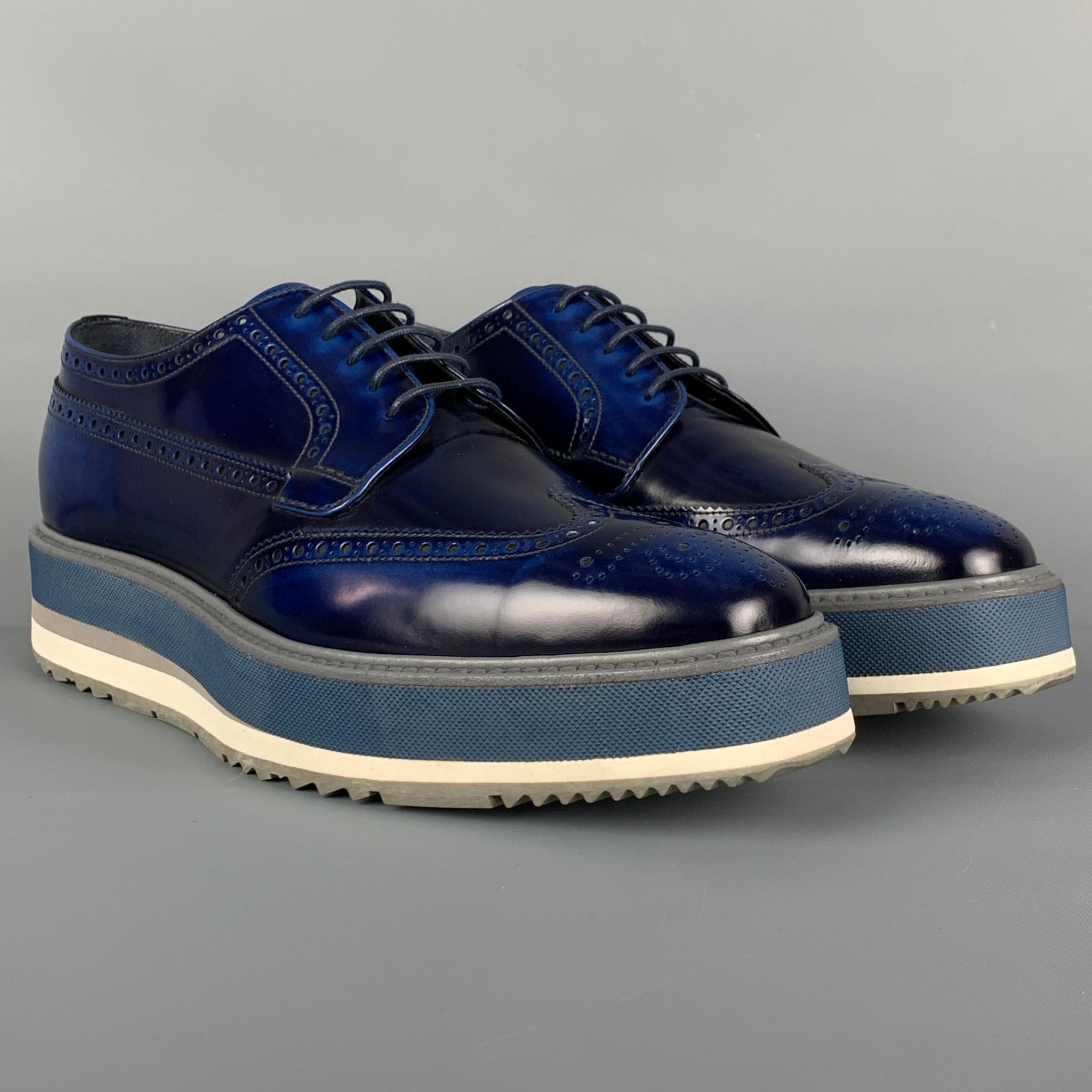 PRADA shoes comes in a blue perforated leather featuring a wingtip style, square toe, platform sole, and a lace up closure. Made in Italy. 

Very Good Pre-Owned Condition.
Marked: 2EG015 UK 8
Original Retail Price: $1,150.00

Outsole: 12.75 in. x