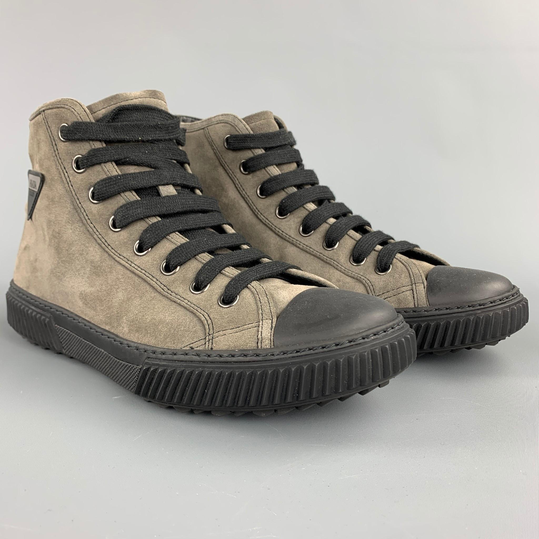 PRADA sneakers comes in a gray suede with a black trim featuring a high top style, side logo, rubber sole, and a lace up closure. Comes with box.

Very Good Pre-Owned Condition.
Marked: 9
Original Retail Price: $595.00

Measurements:

Length: 12