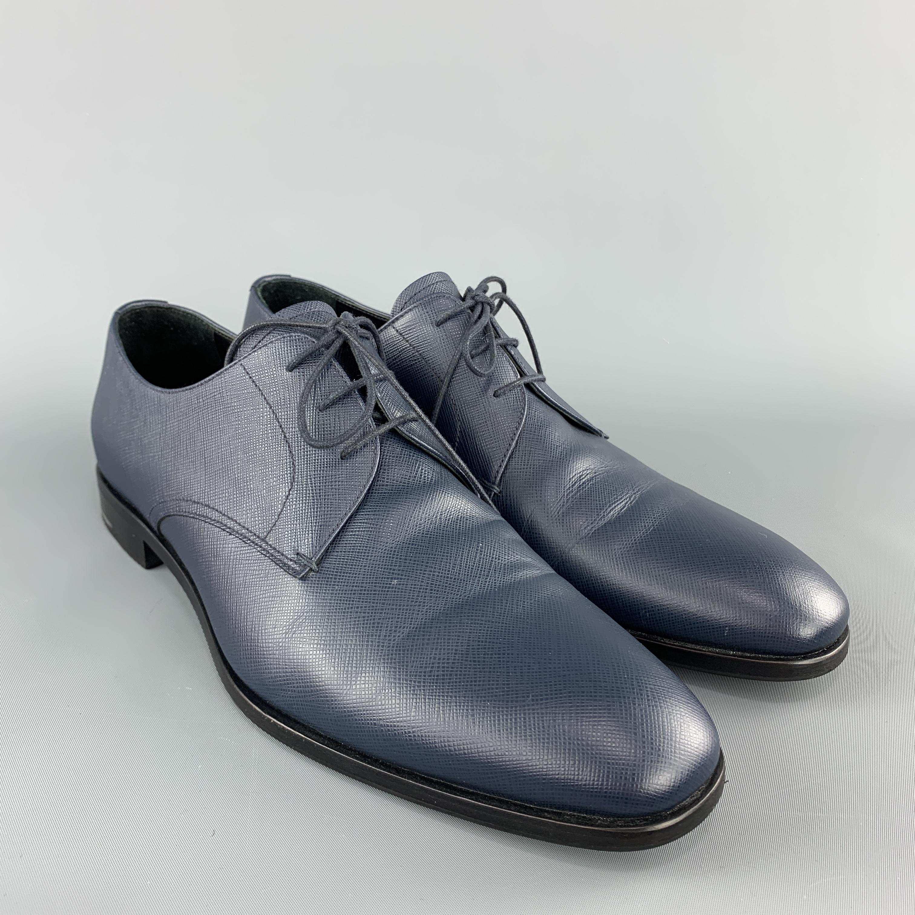 PRADA dress shoes come in navy Saffiano textured leather with a lace up front and squared point toe. Made in Italy.

Excellent Pre-Owned Condition.
Marked: UK 9 

Outsole: 12 x 4 in.