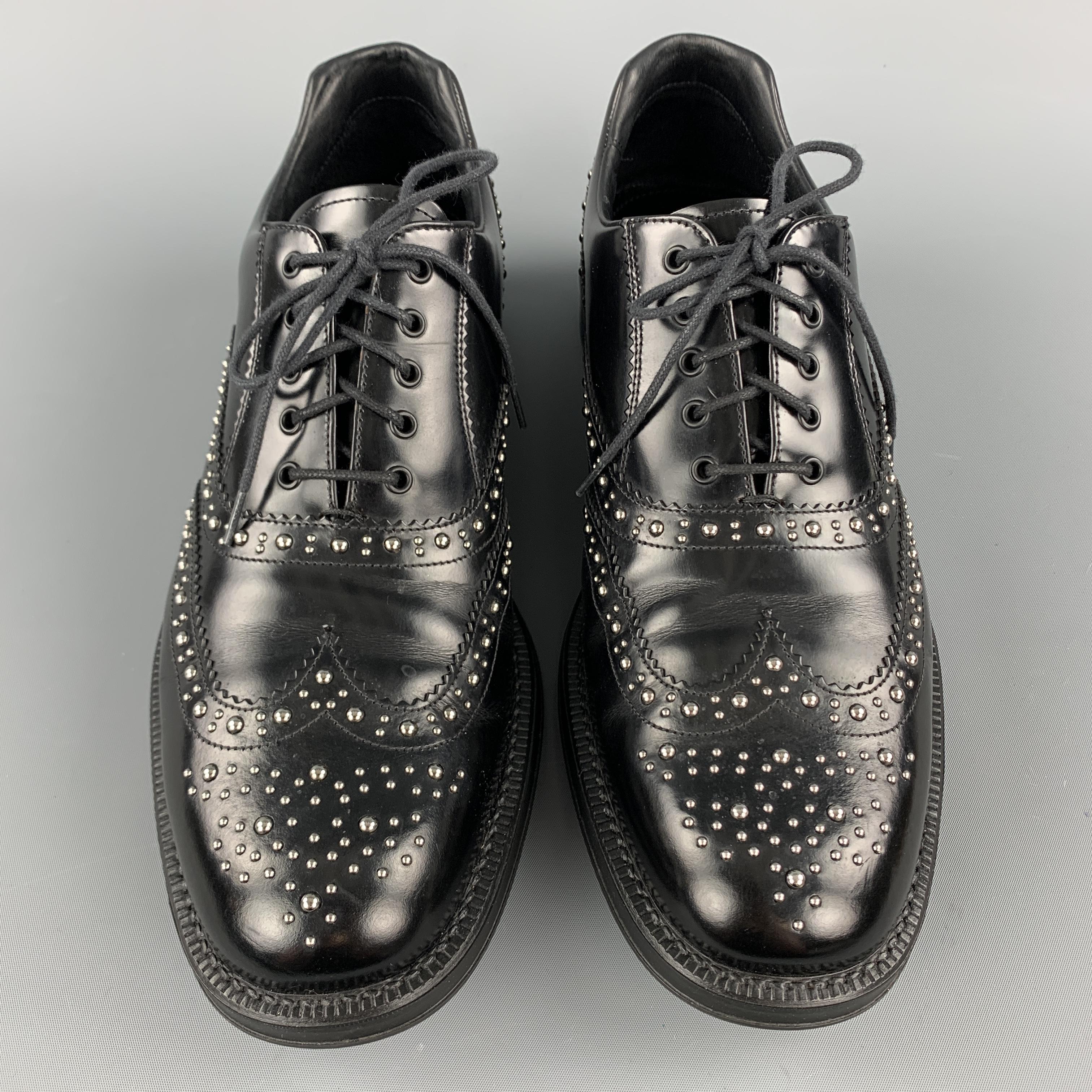 PRADA oxford dress shoes come in black leather with broguing throughout, wingtip, rubber sole, and silver tone studs. With box. Made in Italy.

Excellent Pre-Owned Condition.
Marked: UK 8.5

Outsole: 12 x 4 in.