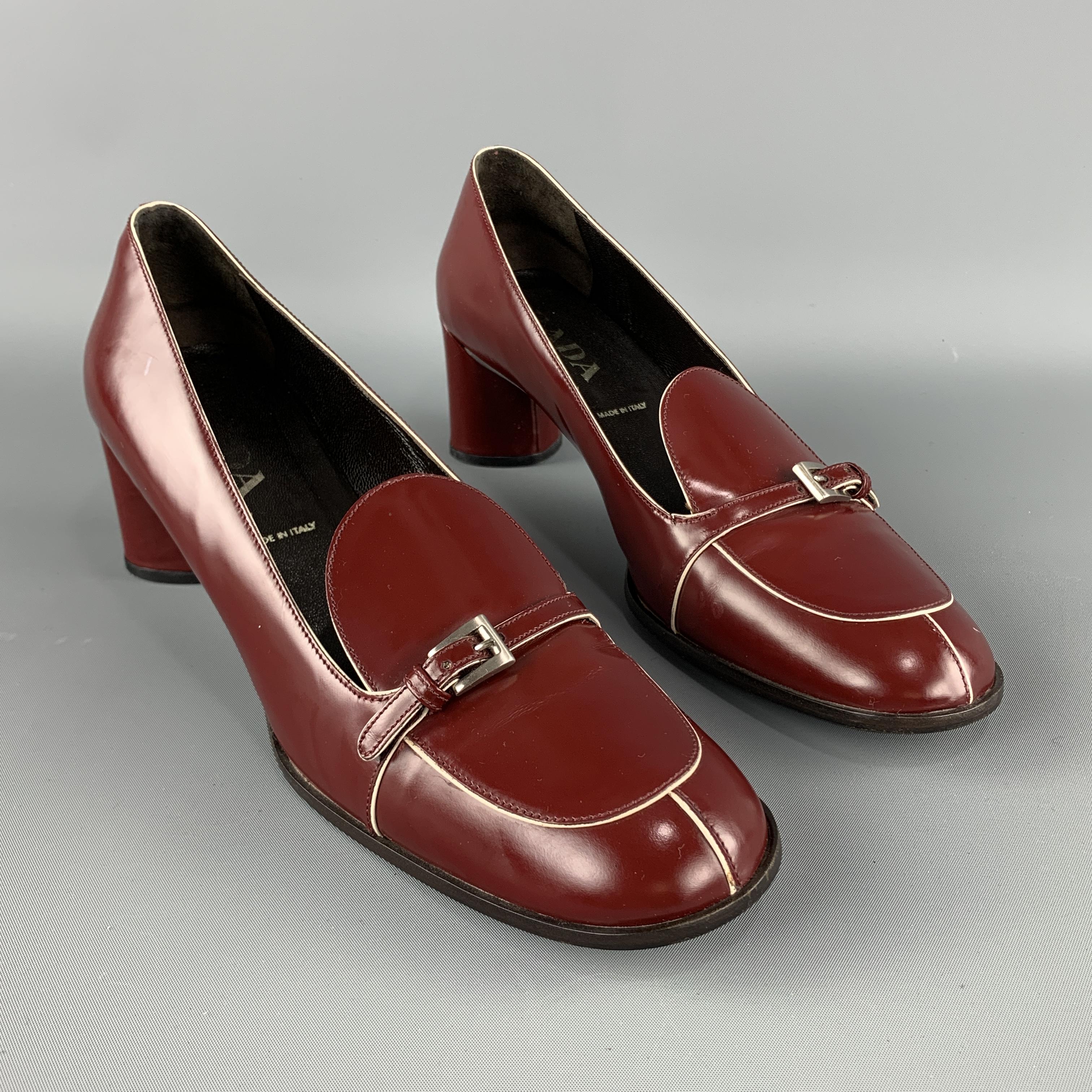 PRADA Loafer Pumps comes in a burgundy tone in a solid leather material, with a rounded toe and a silver tone metal buckle. Made in Italy.
 
Excellent Pre-Owned Condition.
Marked: IT 39 1/2
 
Heel: 2.2 in.