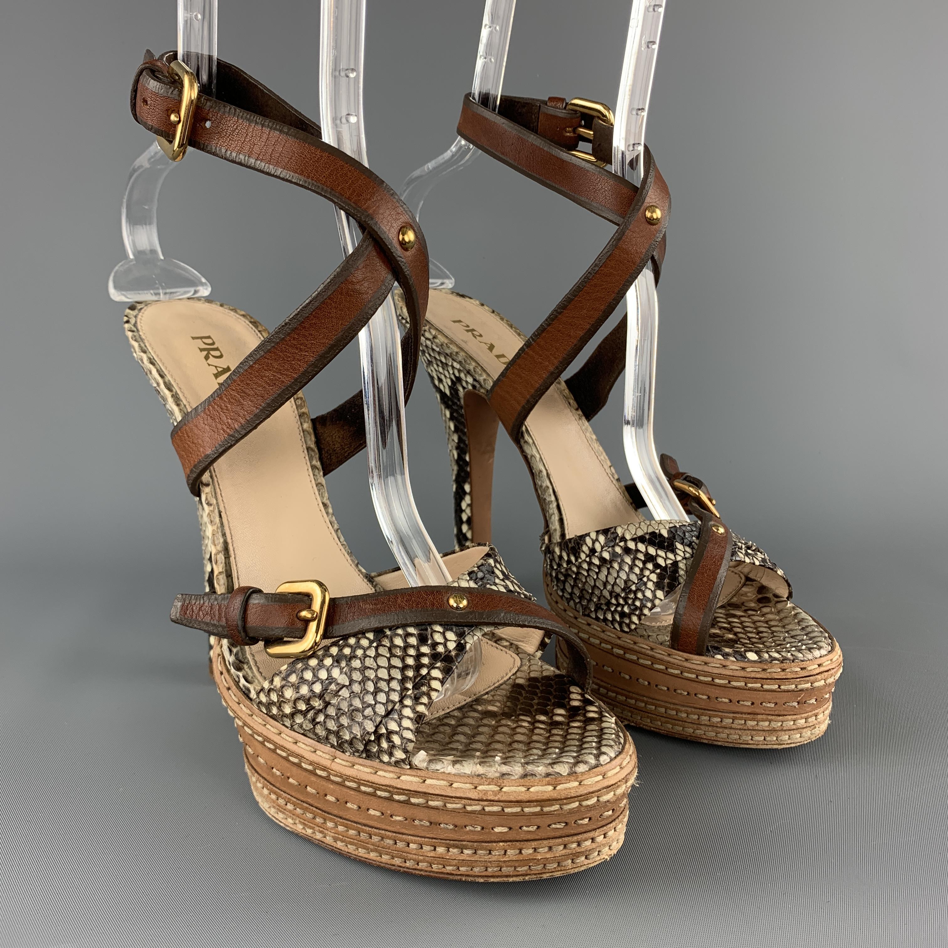 PRADA runway sandals come in gray python skin leather ad feature a chunky covered heel, stacked beige leather panel platform, crossed toe strap, and brown leather ankle strap. Made in Italy.

Good Pre-Owned Condition.
Marked: IT