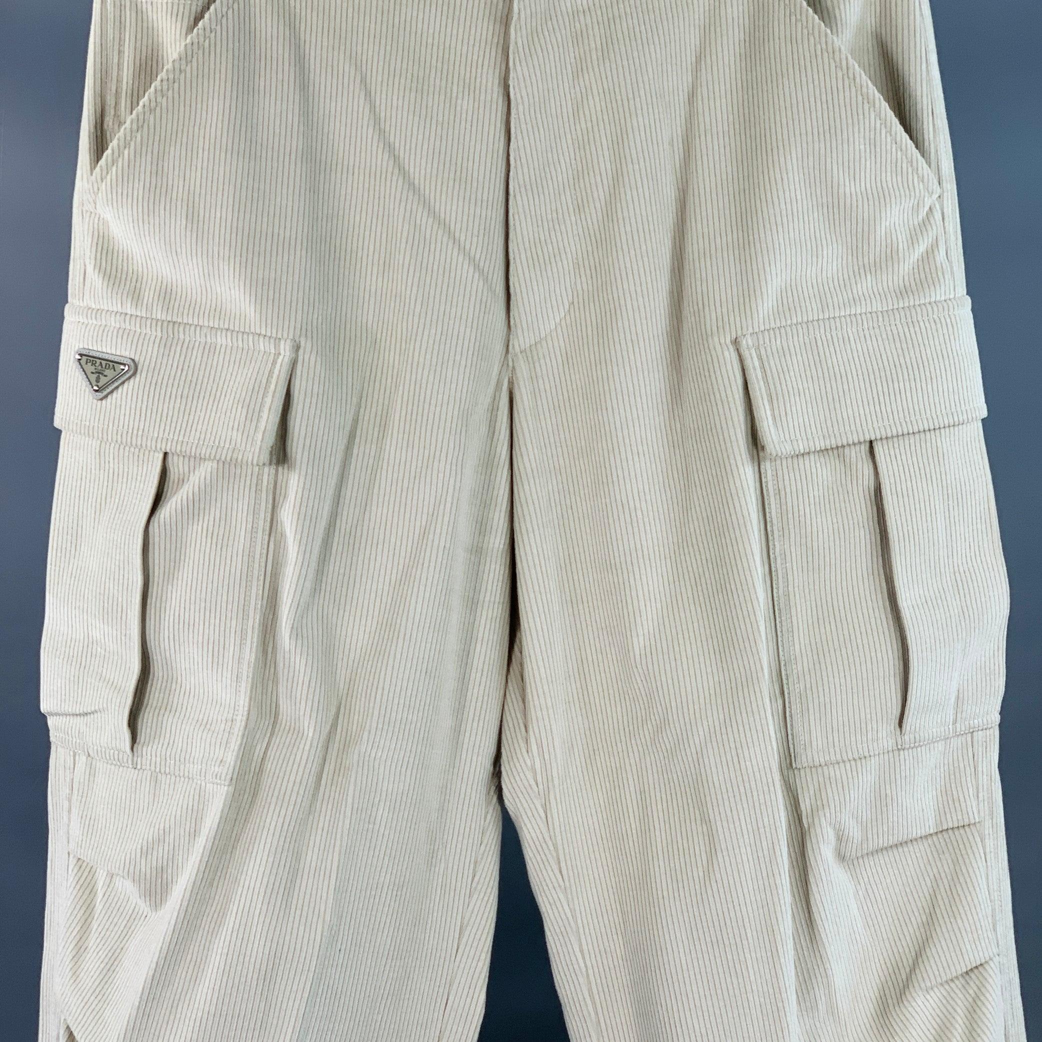 PRADA casual pants
in a stone beige cotton pinwale corduroy featuring a cargo style with multiple large flap pockets, tapered leg with drawstring cuff, and zip fly closure. Excellent Pre-Owned Condition. 

Marked:   L 

Measurements: 
  Waist: 38