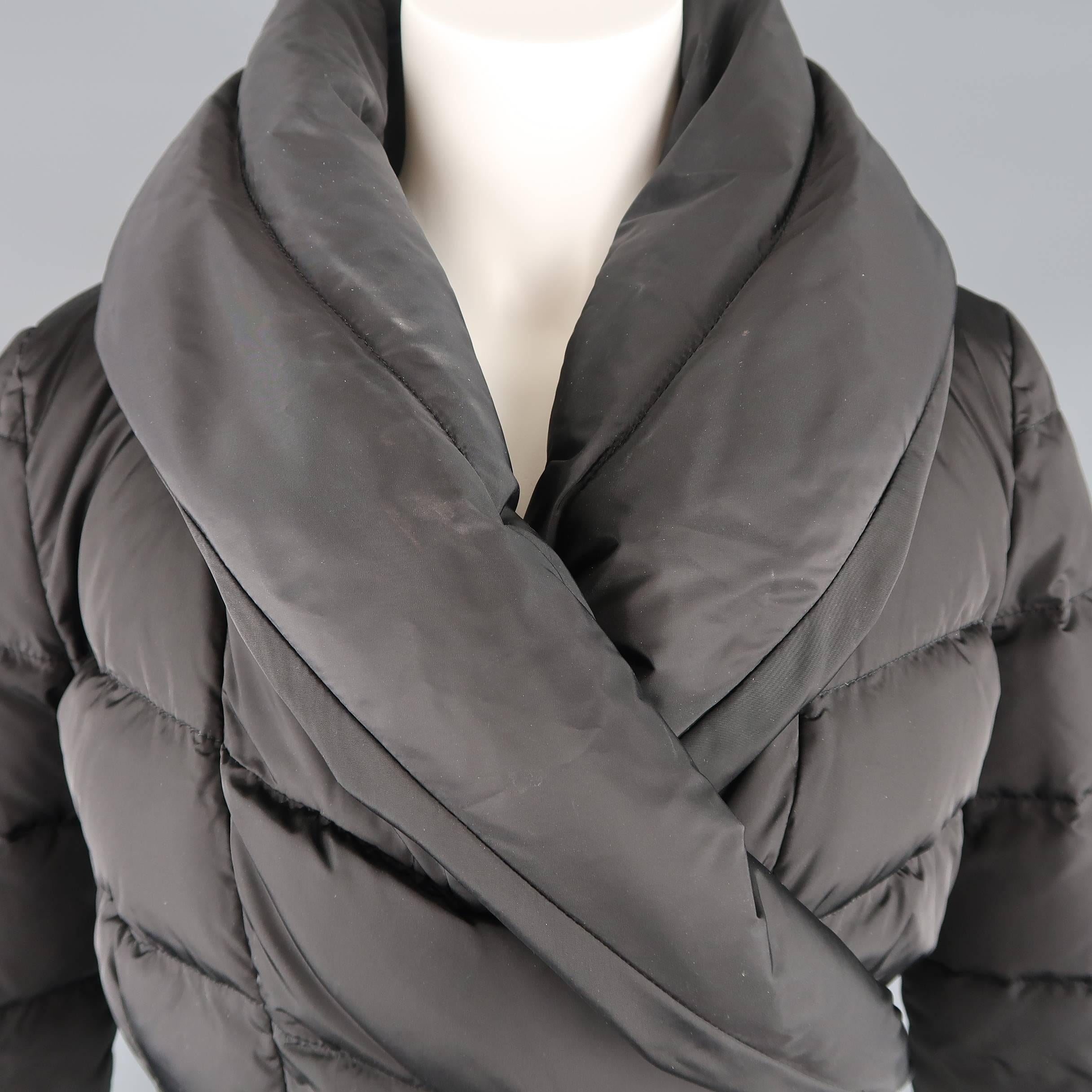 PRADA puffer jacket comes in classic quilted nylon with a fold over collar, cropped silhouette, and wrap closure. Made in Italy.
 
Good Pre-Owned Condition.
Marked: L
 
Measurements:
 
Shoulder: 16 in.
Bust: 42 in.
Sleeve: 19 in.
Length: 14 in.