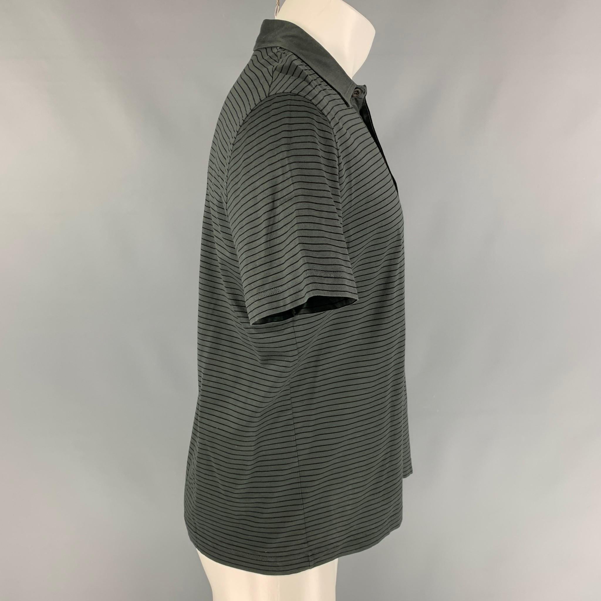 PRADA polo comes in a grey & black stripe cotton featuring a spread collar and a buttoned closure. Made in Italy. 

Very Good Pre-Owned Condition.
Marked: L

Measurements:

Shoulder: 18.5 in.
Chest: 42 in.
Sleeve: 9 in.
Length: 26.5 in. 