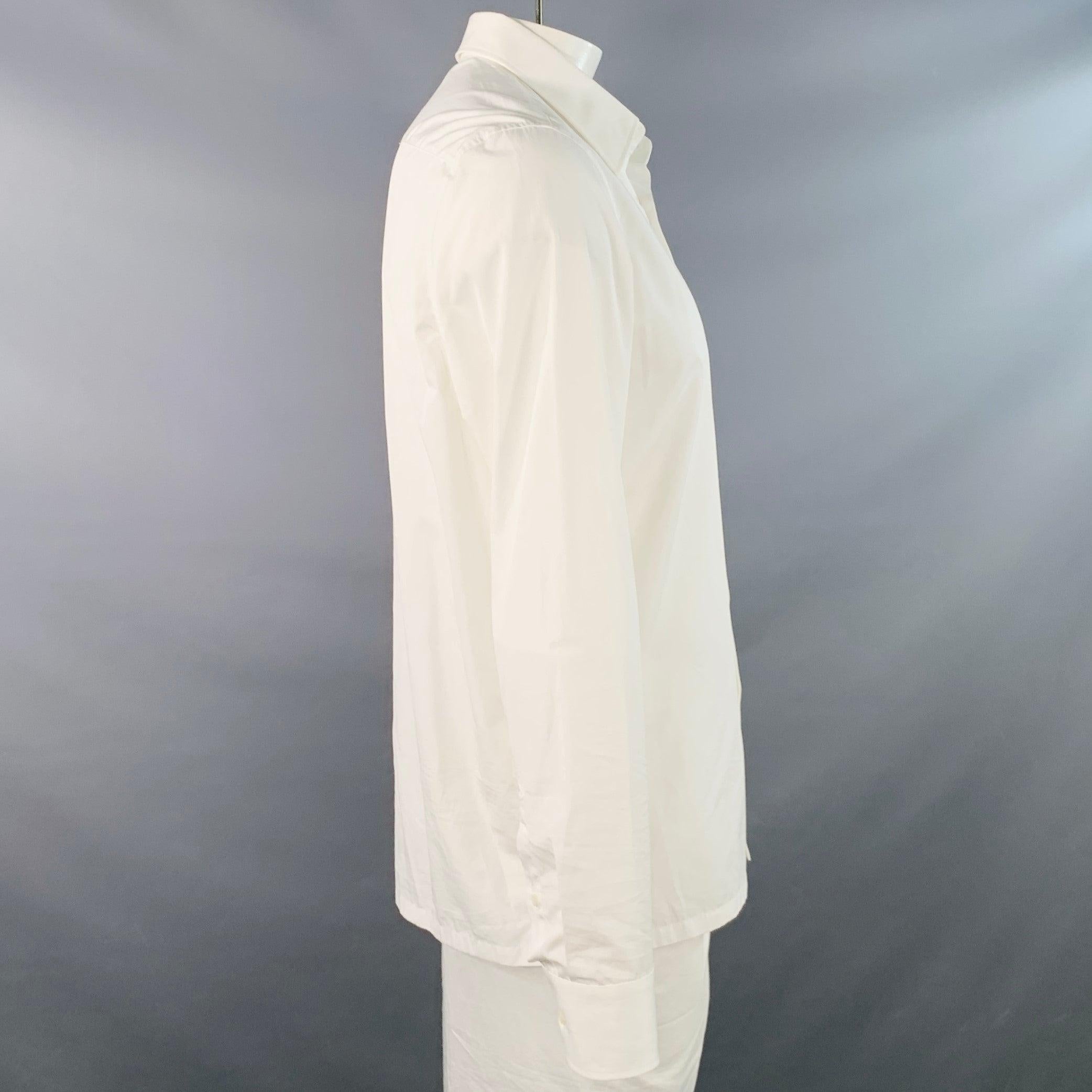 Camicia a maniche lunghe di Prada
in tessuto di cotone bianco con colletto curvo, polsini a botte arrotondati con un solo bottone e chiusura con bottoni. Made in Italy.Ottime condizioni di usato. Piccoli segni di usura. 

Contrassegnato:   42/16.5