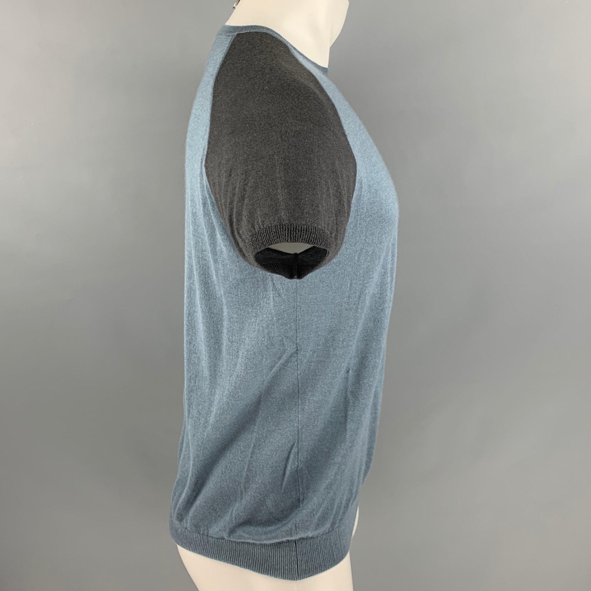 PRADA short sleeve pullover comes in a blue and grey cashmere silk blend, featuring color block pattern, and crew neck. Made in Italy.Very Good Pre-Owned Condition. Minor signs of wear. 

Marked:   50 

Measurements: 
 
Shoulder: 17 inches Chest: 41