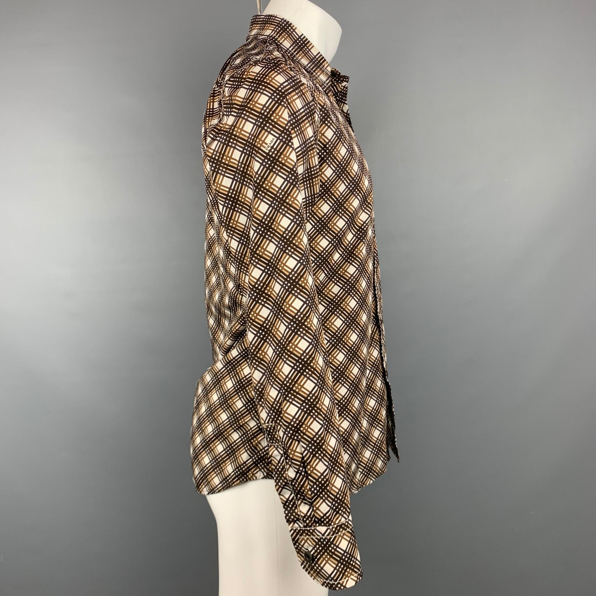 PRADA long sleeve shirt comes in a brown & white plaid cotton featuring a button up style, patch pocket, contrast stitching, and a spread collar. Made in Italy.

Very Good Pre-Owned Condition.
Marked: 40/15

Measurements:

Shoulder: 17 in.
Chest: 42