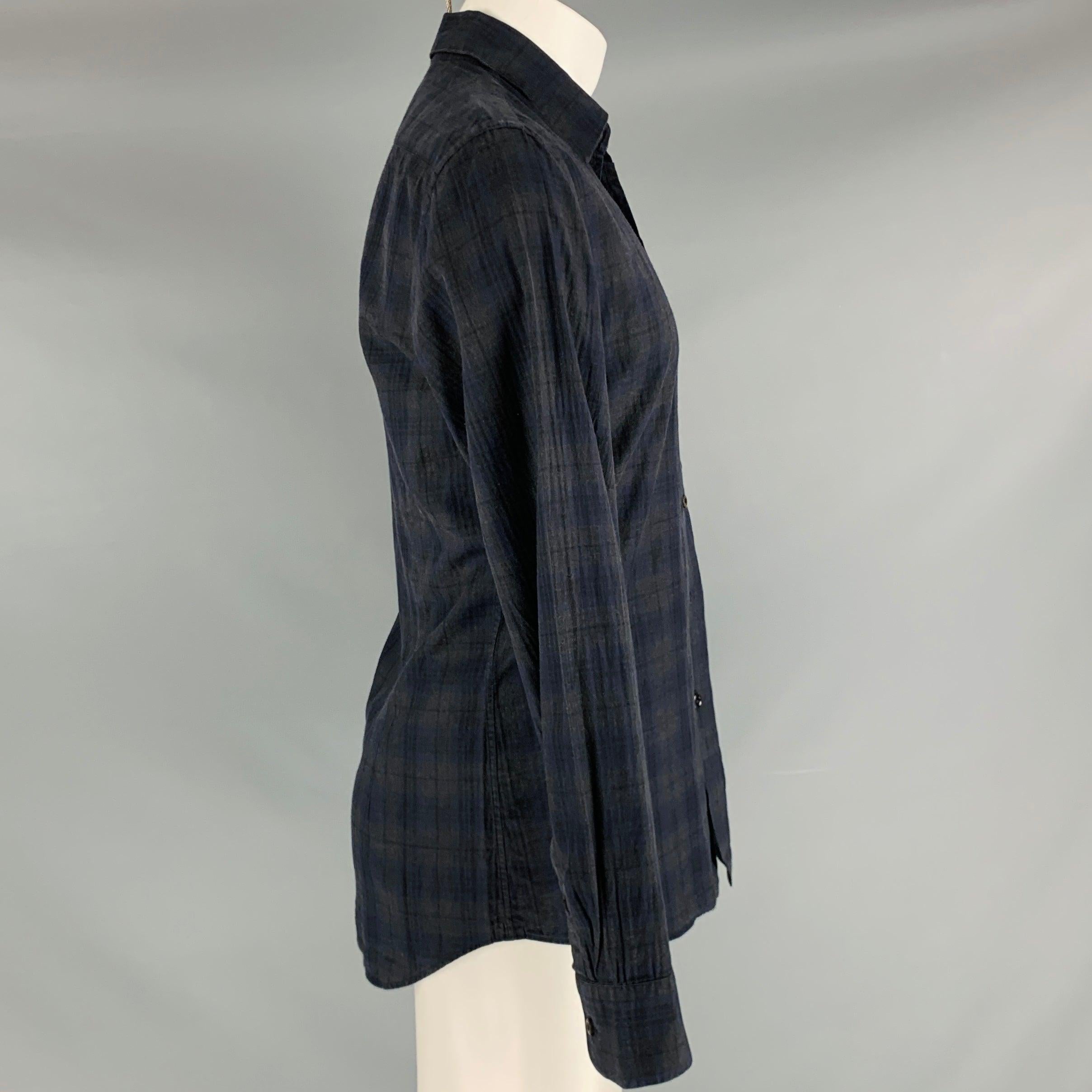 PRADA long sleeve shirt
in a charcoal grey and navy cotton fabric featuring plaid pattern, spread collar, and button closure. Made in Italy.Very Good Pre-Owned Condition. Missing middle button, as is. 

Marked:   40/15.75 

Measurements: 
