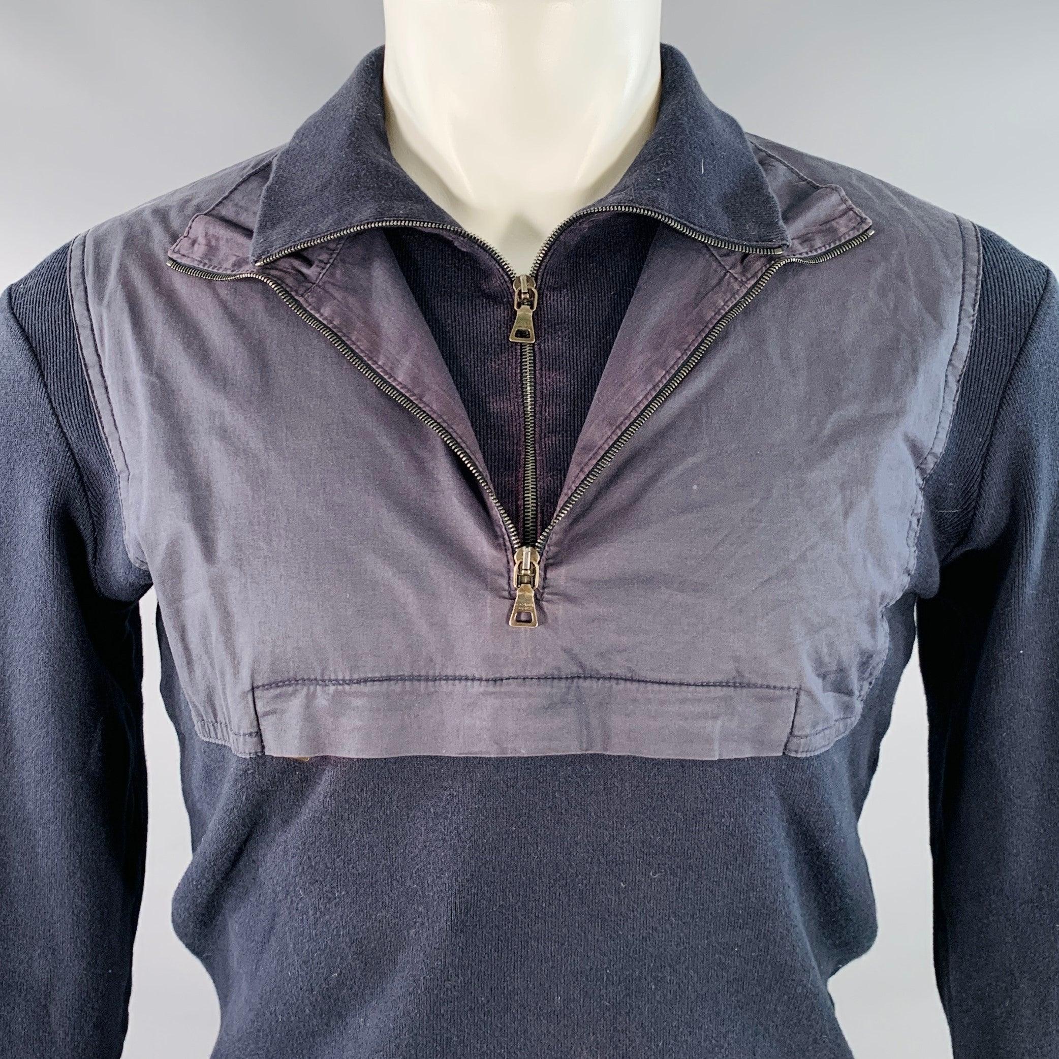 PRADA pullover
in a navy cotton knit featuring long sleeves, and double layered collar with woven panel and 1/4 zip closures. Made in Italy.Very Good Pre-Owned Condition. Signs of wear on woven panel. 

Marked:   IT 50 

Measurements: 
 
Shoulder:
