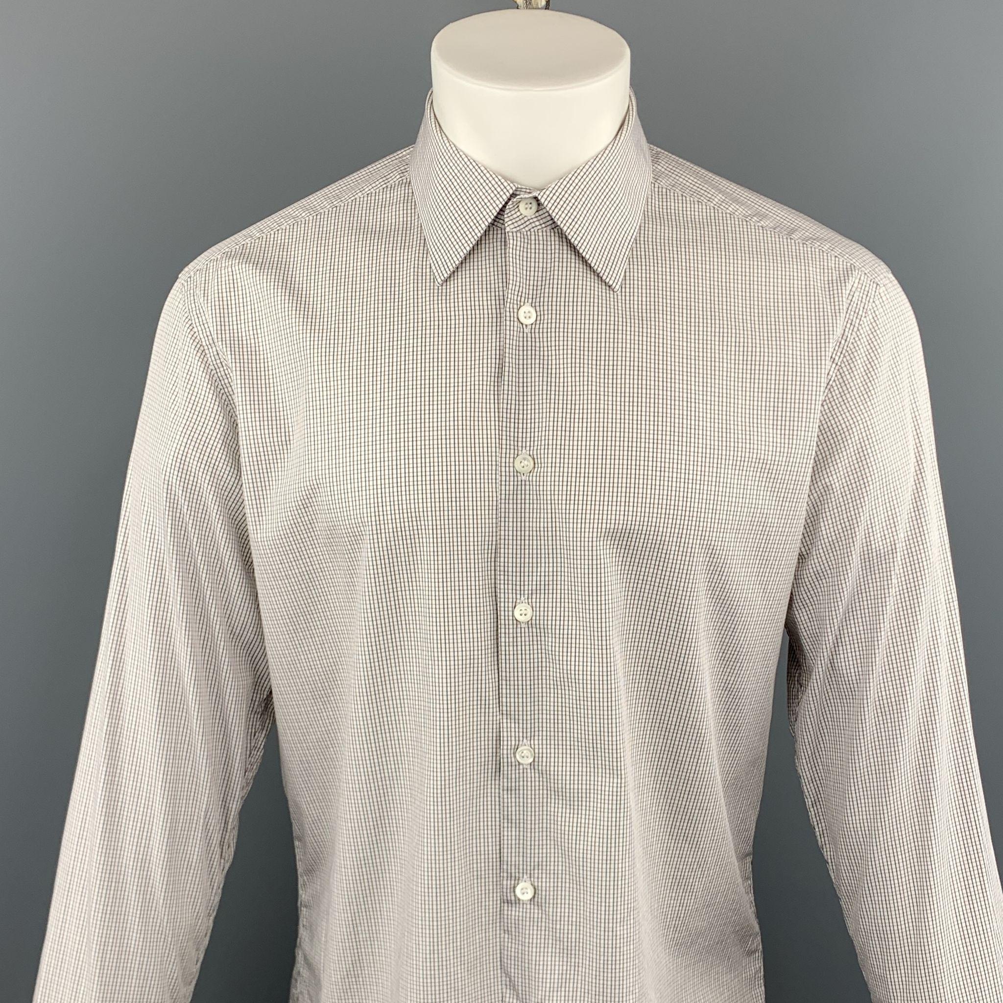 PRADA long sleeve shirt comes in a white and navy plaid cotton featuring a button up style and a spread collar. Made in Italy.
 
Excellent Pre-Owned Condition.
Marked: 41
 
Measurements:
 
Shoulder: 18 in.
Chest: 46 in.
Sleeve: 27.5 in.
Length: 26.5