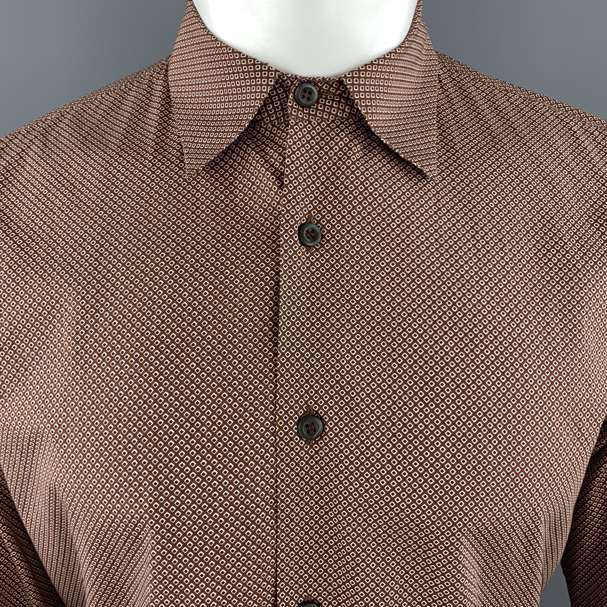 PRADA dress shirt comes in brown cotton with an all over white and navy retro dot print . Made in Italy.

Excellent Pre-Owned Condition.
Marked: US 40 / 15 3/4

Measurements:

Shoulder: 17 in.
Chest: 44 n.
Sleeve: 26 in.
Length: 30.5 in.
