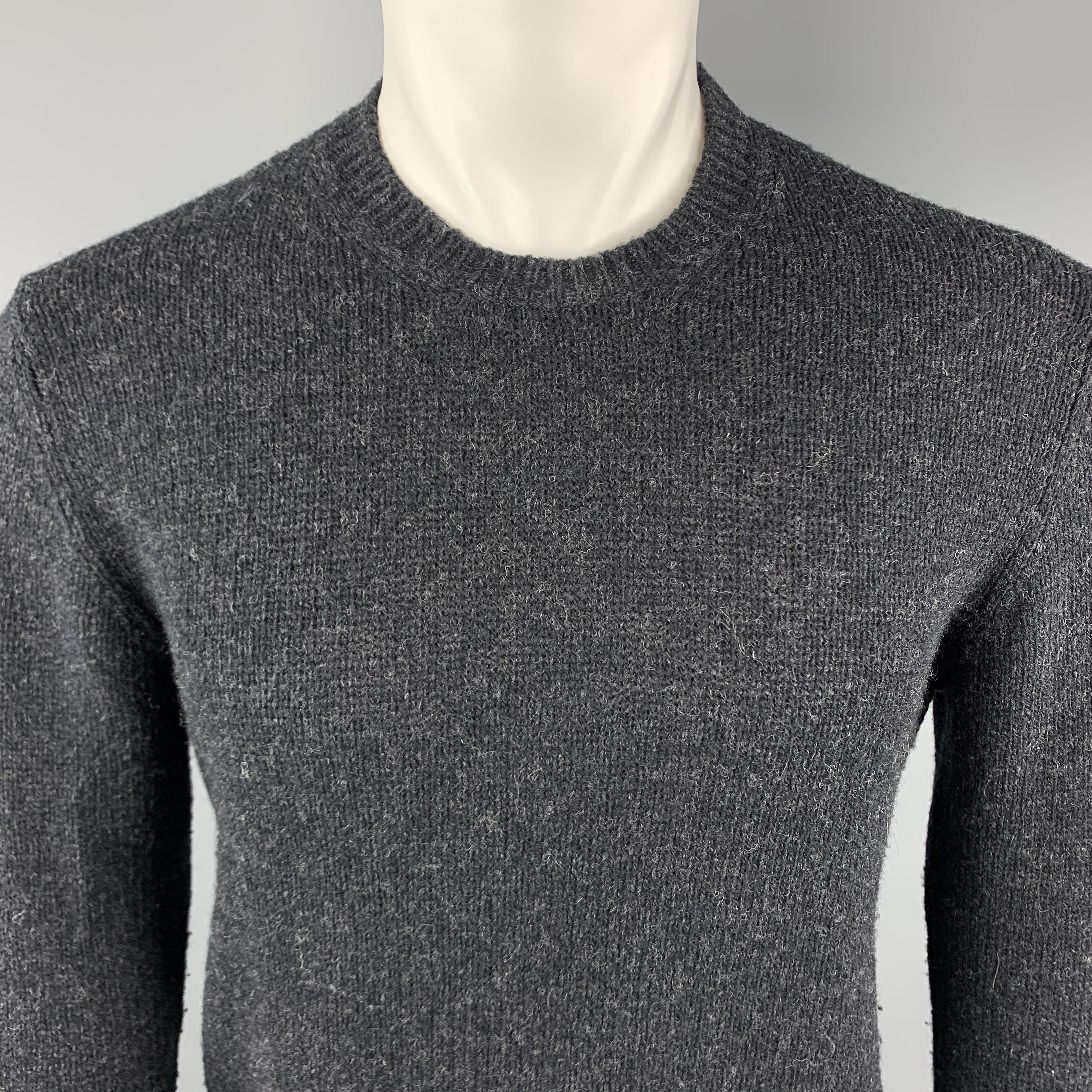 PRADA Pullover Sweater comes in a charcoal knitted wool blend material, featuring a crew-neck, suede elbow patches, and ribbed cuffs and hem. Made in Italy. 

Excellent Pre-Owned Condition.
Marked: IT 48

Measurements:

Shoulder: 17 in.
Chest: 39