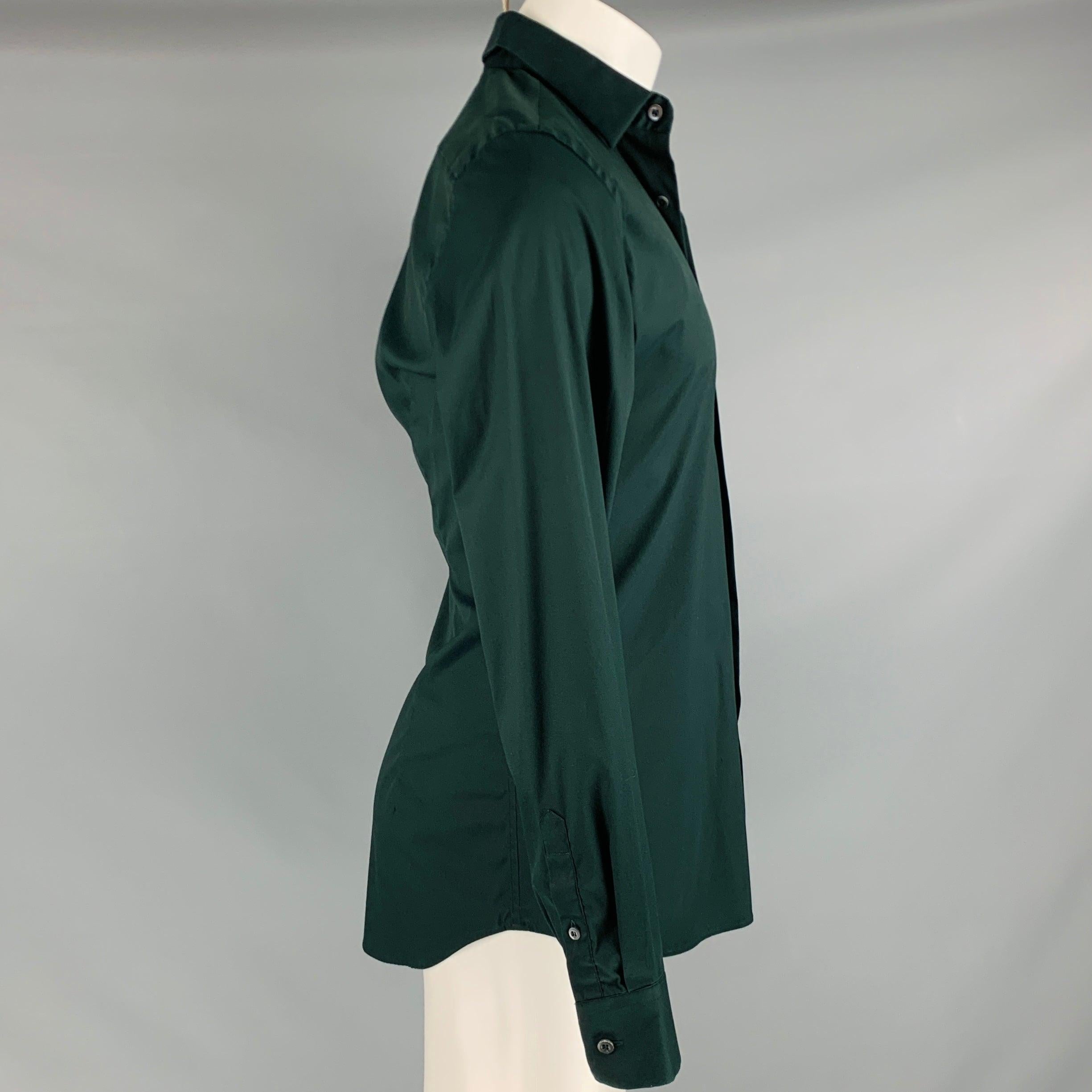 PRADA long sleeve shirt
in a
stretchy green cotton blend fabric featuring spread collar and button closure. Made in Italy.Very Good Pre-Owned Condition. Chipped button. 

Marked:   38/15 

Measurements: 
 
Shoulder: 17.5 inches Chest: 41 inches