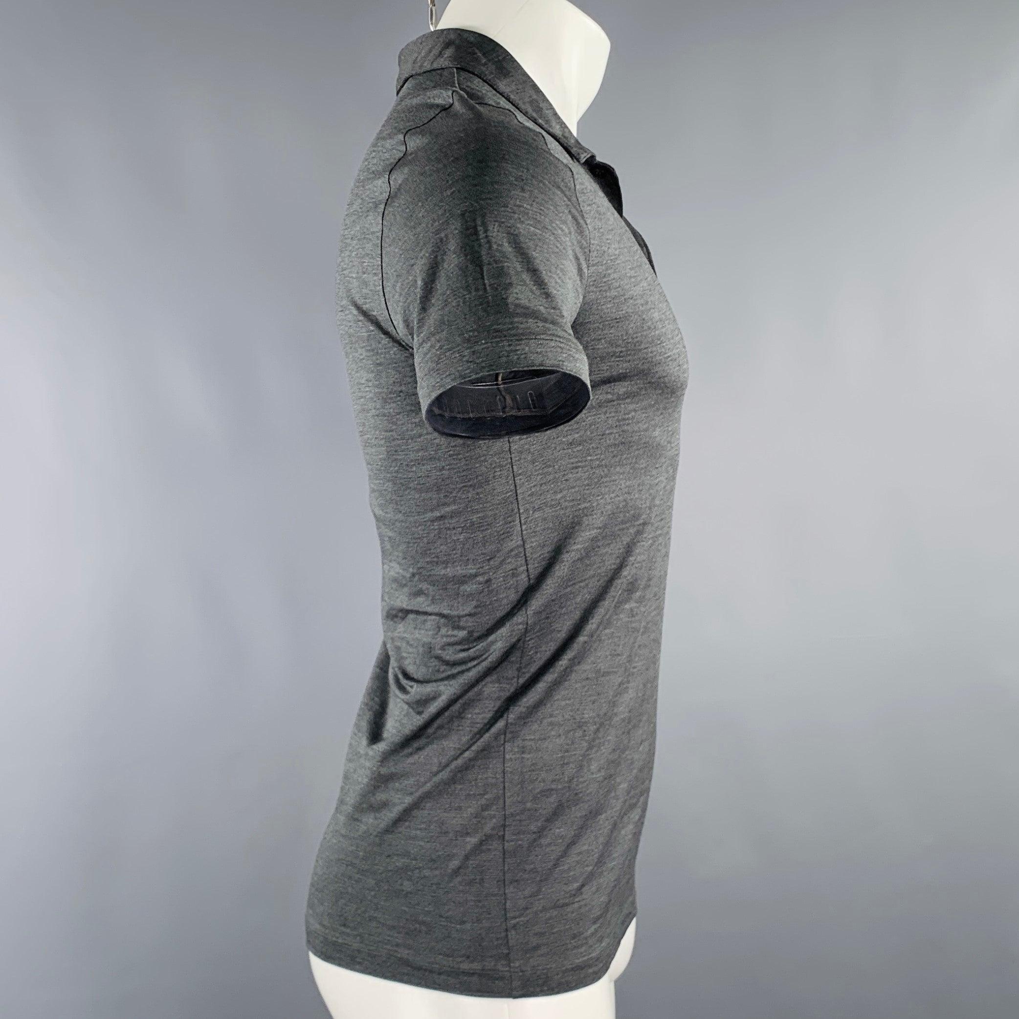PRADA polo
in a grey shimmery fabric featuring short sleeves, one pocket, and half placket button closure. Excellent Pre-Owned Condition. Brand tags removed. 

Marked:   S 

Measurements: 
 
Shoulder: 15 inches Chest: 33 inches Sleeve: 8.5 inches