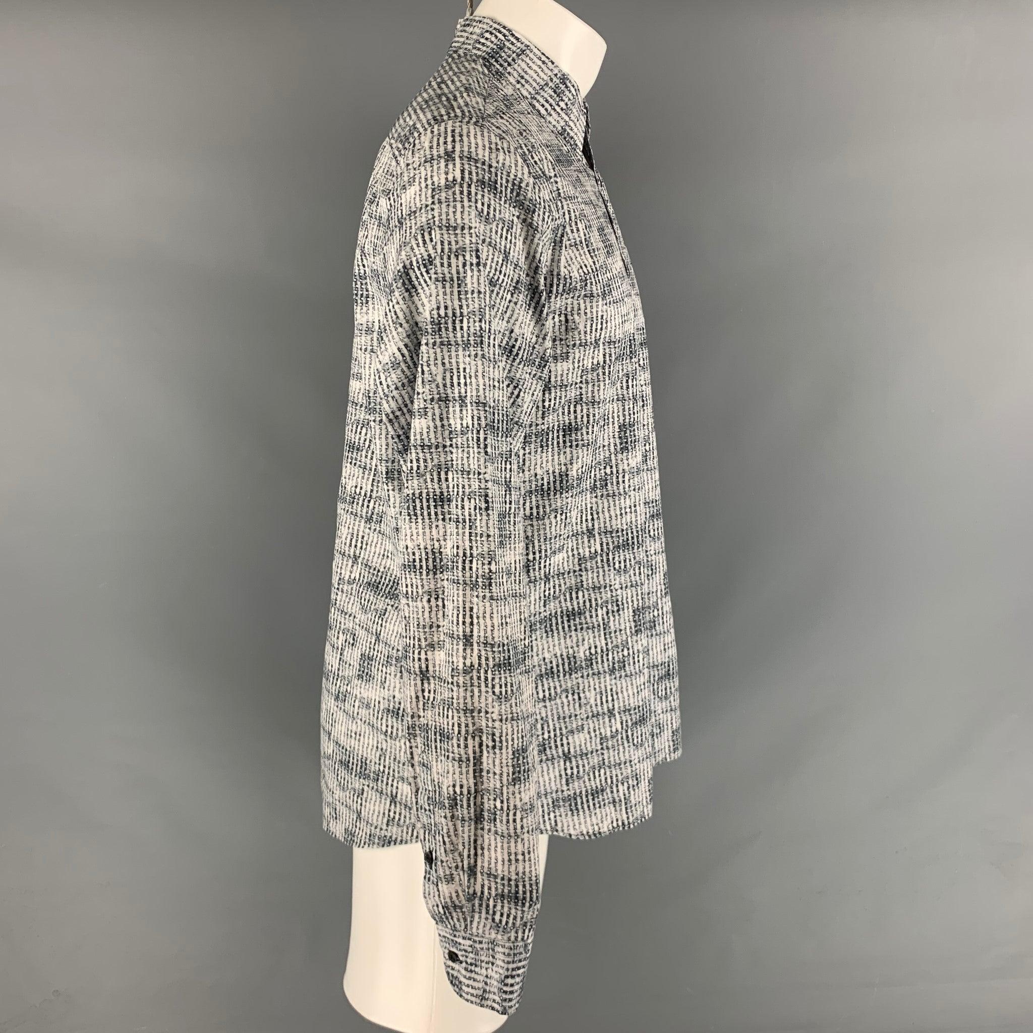 PRADA long sleeve shirt comes in a white and grey cotton abstract print featuring a button up style and a spread color. Made in Italy.Excellent Pre-Owned Condition. 

Marked:   42 & 16 1/2
 

Measurements: 
 
Shoulder: 17 inches Chest: 43 inches