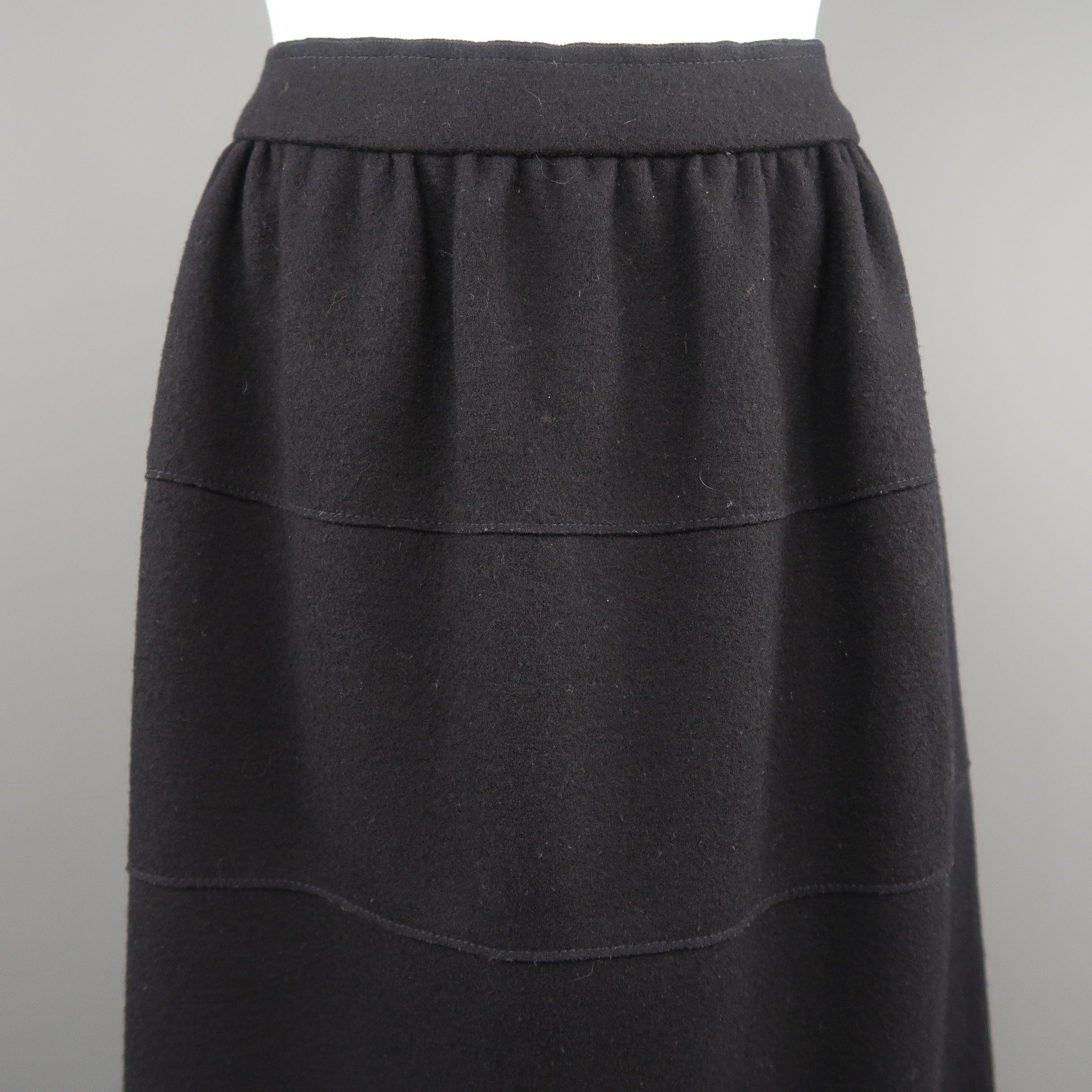 PRADA circle skirt comes in navy virgin wool with a gathered waistband, unlined, tired panel construction. Made in Italy.Excellent Pre-Owned Condition. 

Marked:   IT 40 

Measurements: 
  Waist:
 30 inches Hip: 46 inches Length: 20 inches 
  
  
