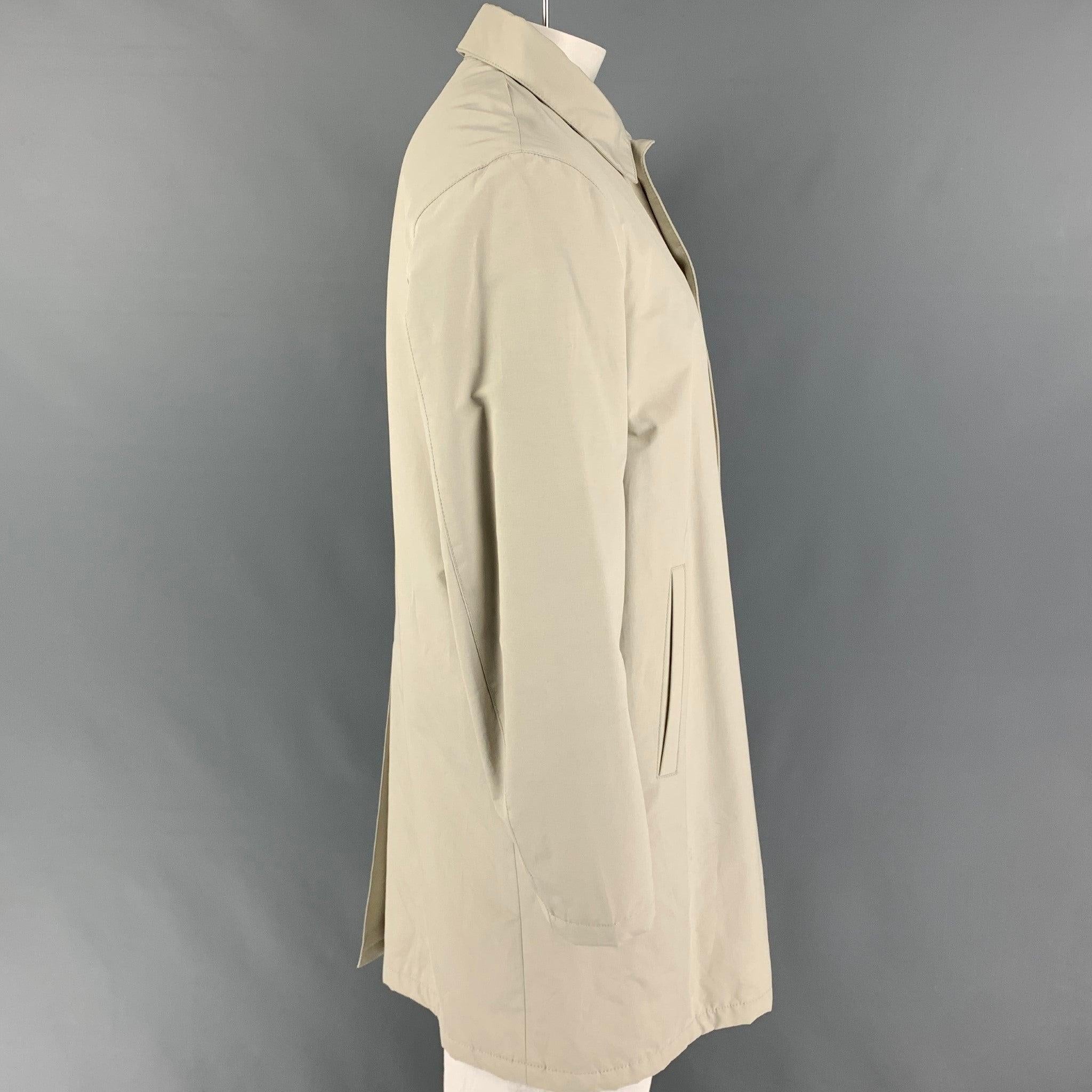 PRADA coat comes in a beige cotton / polyester featuring a spread collar, slit pockets, single back vent, and a buttoned closure. Made in Romania.
 Very Good
 Pre-Owned Condition. 
 

 Marked:  54 
 

 Measurements: 
  
 Shoulder: 19.5 inches Chest: