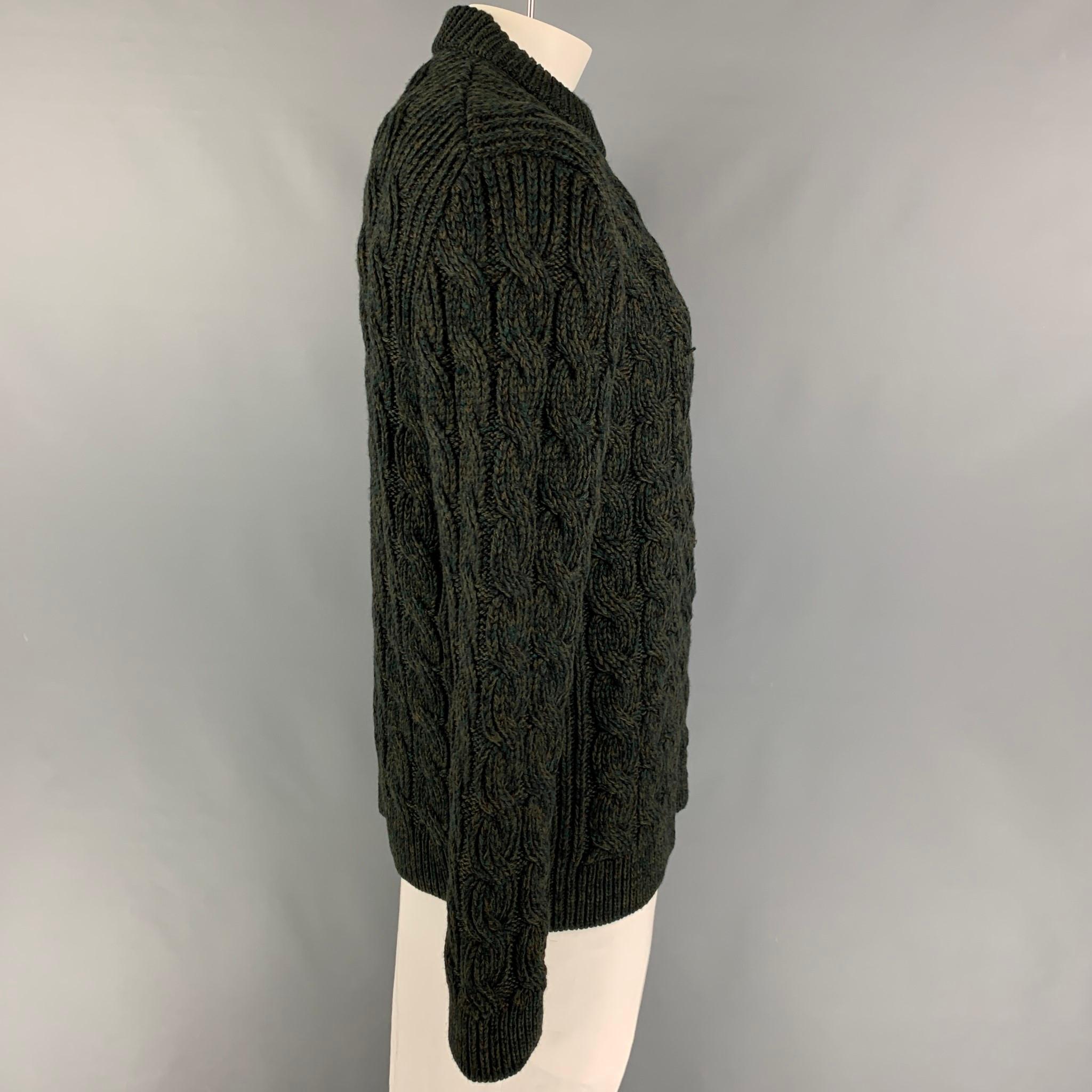 PRADA sweater comes in a green & olive chunky knit virgin wool  featuring a crew-neck. Made in Italy. 

Very Good Pre-Owned Condition.
Marked: 56

Measurements:

Shoulder: 18 in.
Chest: 46 in.
Sleeve: 28 in.
Length: 30 in. 