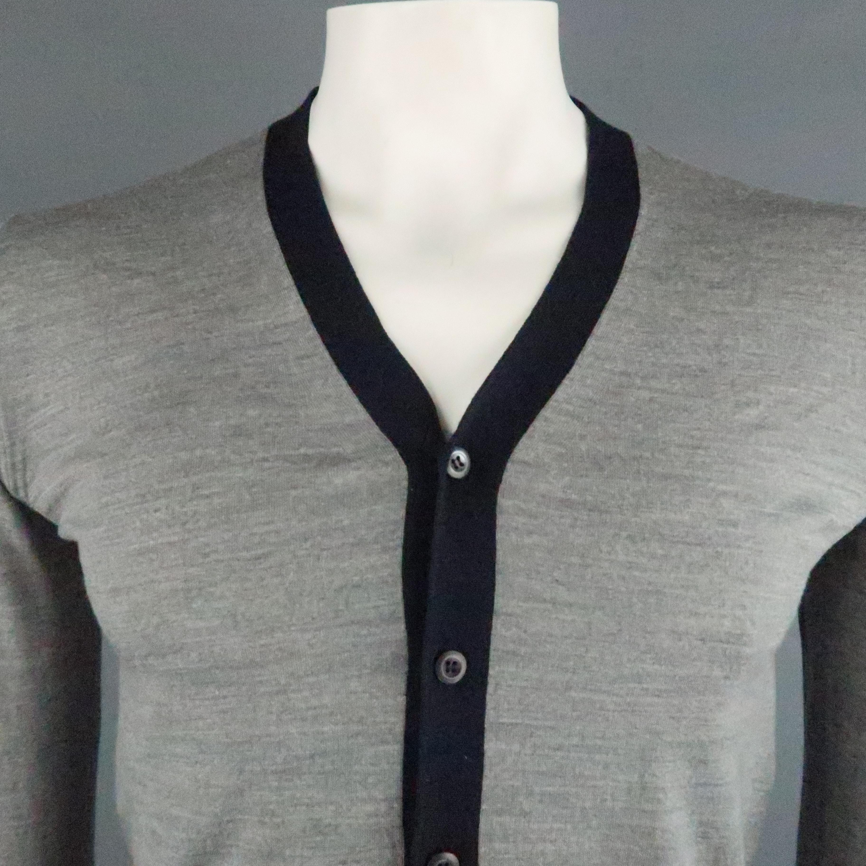 PRADA cardigan comes in a navy cotton featuring a navy trim. Made in Italy.
 
Excellent Pre-Owned Condition.
Marked: IT 46
 
Measurements:
 
Shoulder: 17 in.
Chest: 38 in.
Sleeve: 26 in.
Length: 23.5 in.