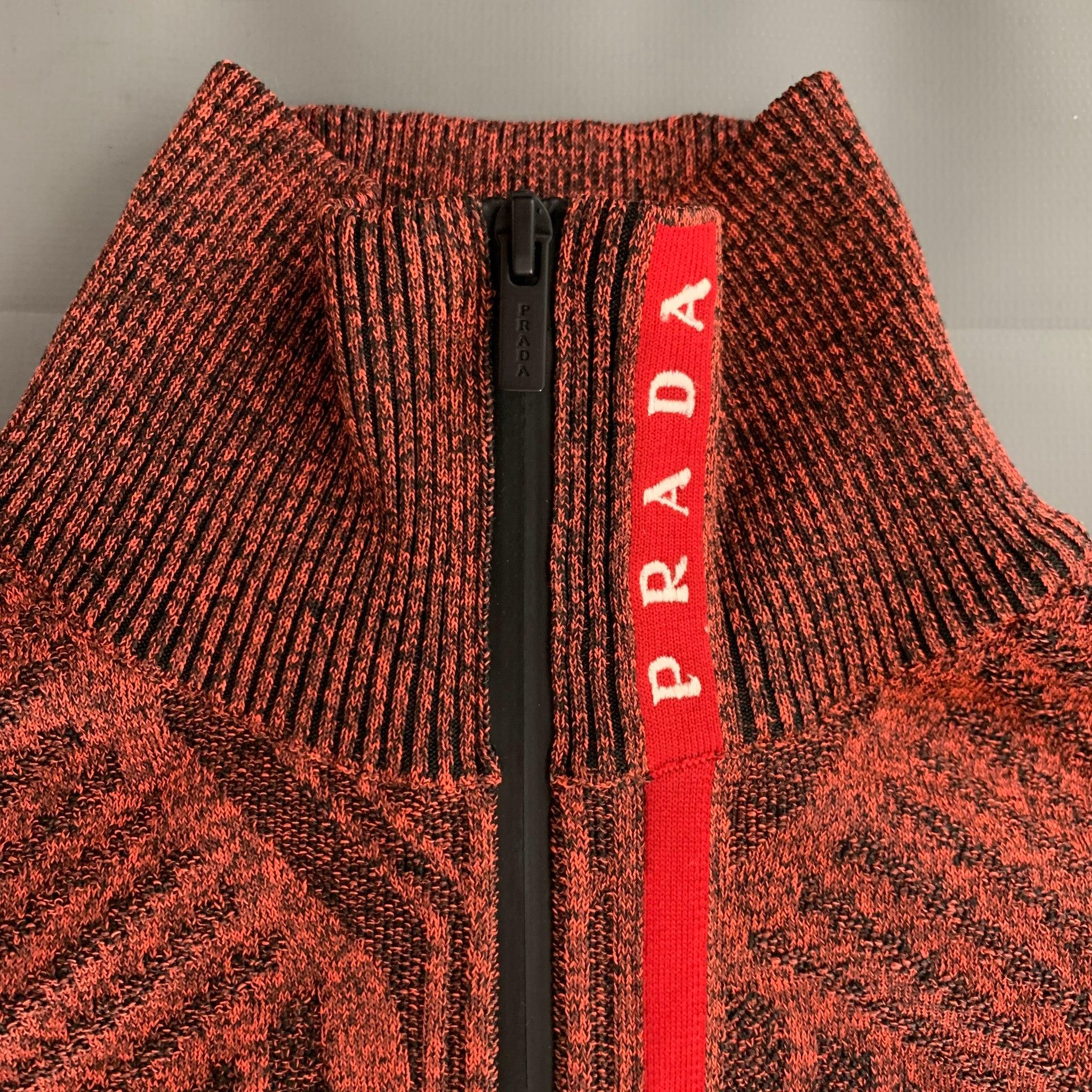 PRADA SPORT crop top comes in orange and black japanese yard knit material featuring a 1/4 zipper detail, and high neck. Made in Italy.Excellent Pre-Owned Condition. 

Marked:   XS 

Measurements: 
  Bust: 31 inches Length: 15 inches  
  
  
