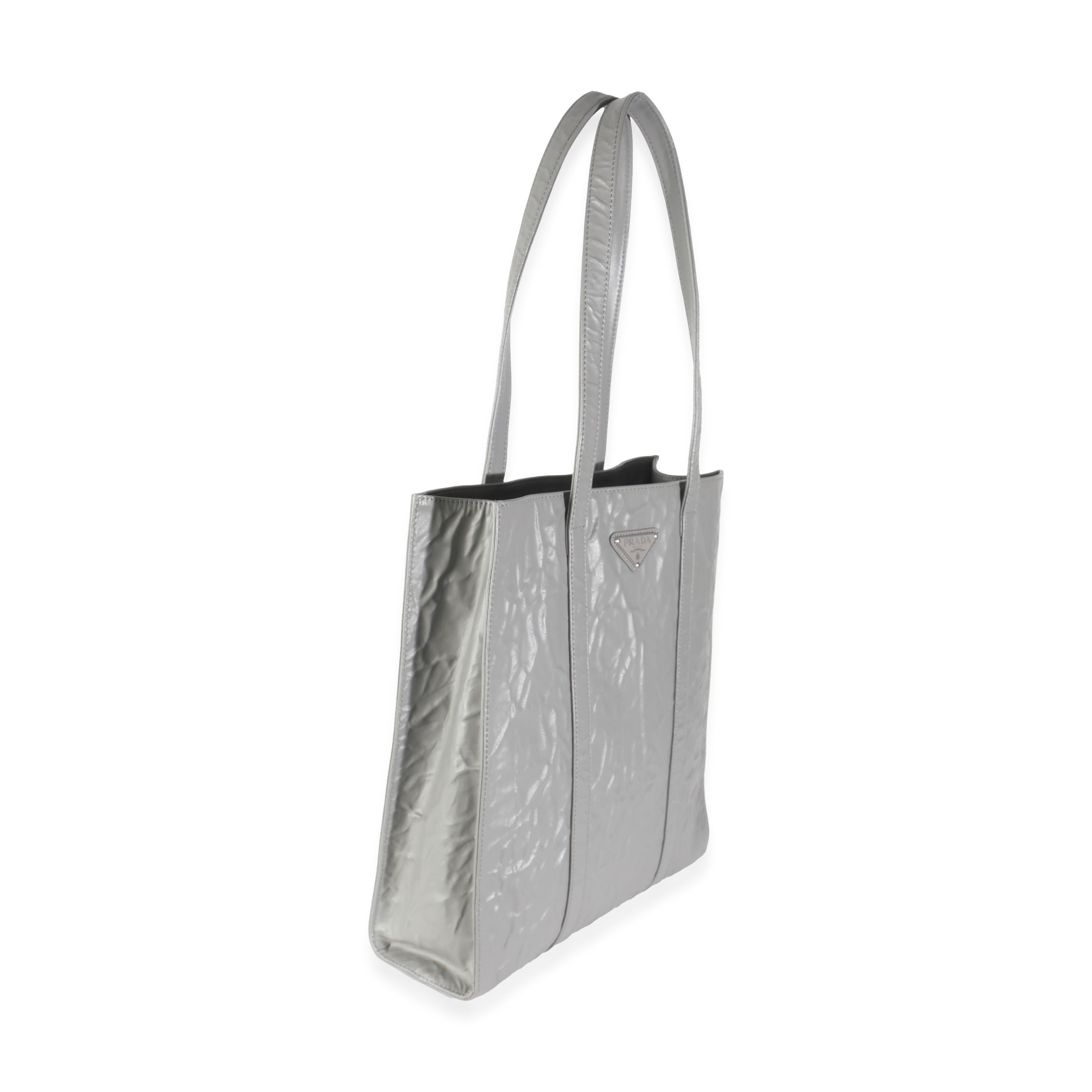 Listing Title: Prada Slate Grey Nappa Small Antique Tote
SKU: 144572
Condition: Pre-owned 
Handbag Condition: Excellent
Condition Comments: Item is in excellent condition and displays light signs of wear. Faint corner scuffing.
Brand: Prada
Model: