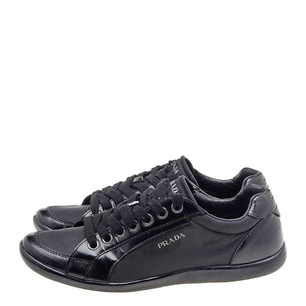 Prada Sport brings you these super stylish sneakers to elevate your appearance! They are crafted using black leather and nylon into a sturdy low-top silhouette. They exhibit lace-up fastenings and gunmetal-tone hardware. Walk with style and