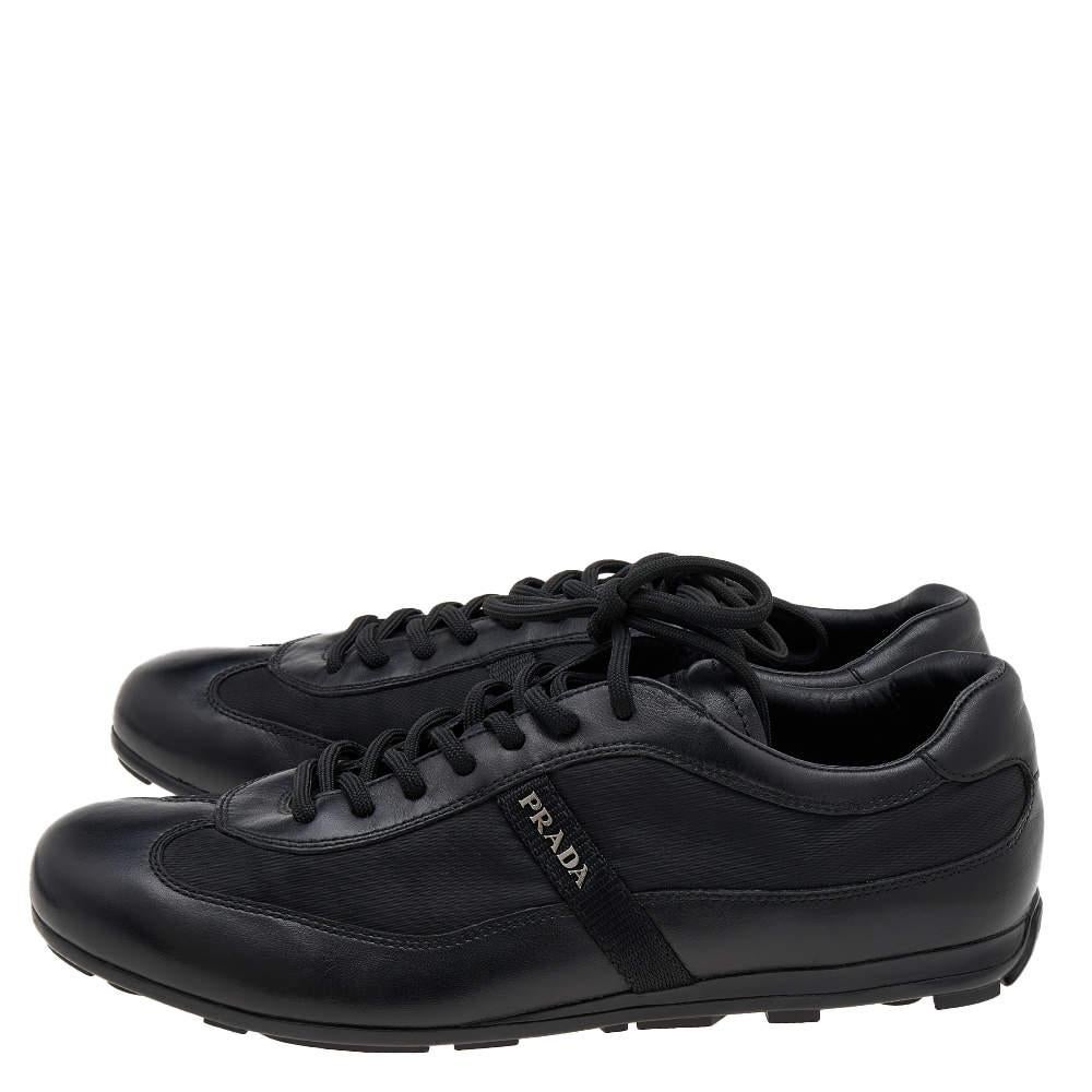 Coming in a classic low-top silhouette, these Prada Sport sneakers are a seamless combination of luxury, comfort, and style. They are made from leather and nylon in a black shade. These sneakers are designed with logo details, laced-up vamps, and