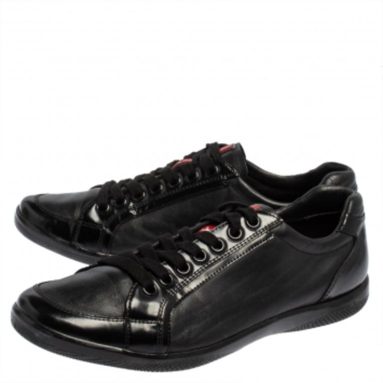 These black low-top sneakers from Prada Sport are just what you need to add to your style. They are crafted from patent leather and leather and feature round toes, lace-ups, and logo details on the tongues. They offer a comfortable fit with their