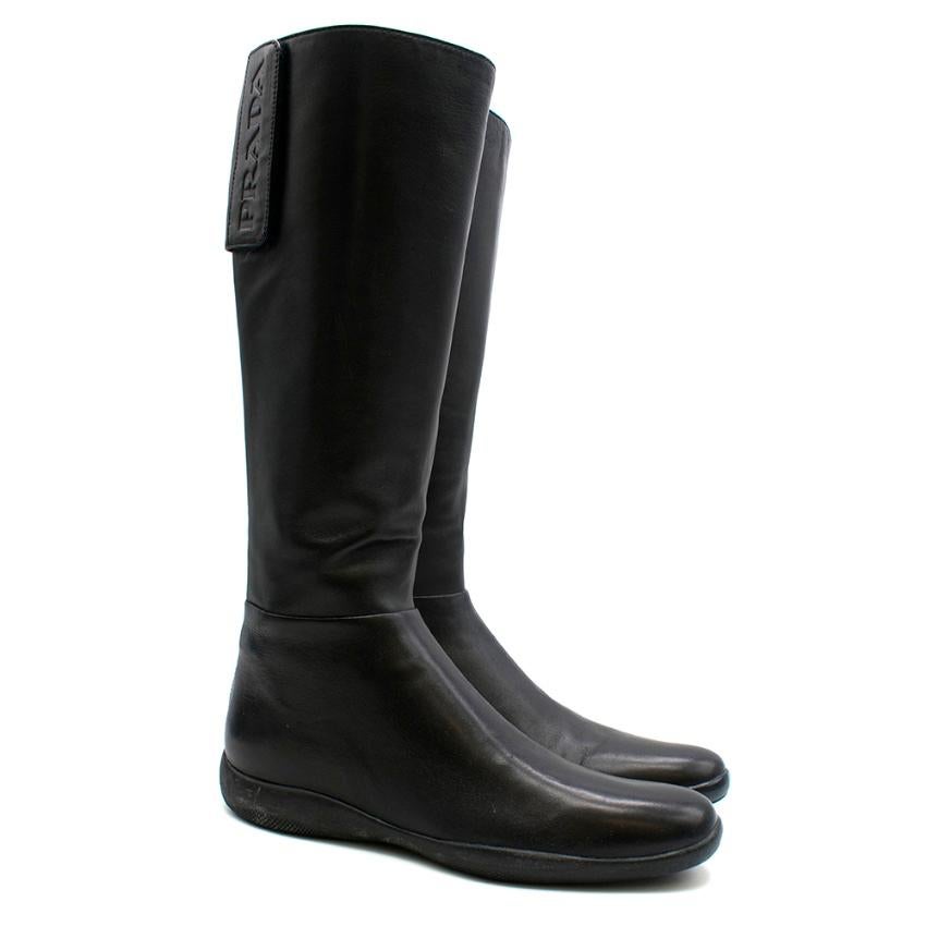 Prada Sport - black flat knee high boots

- rubber soles with red Prada logo - zip closure at the back - velcro fastening with Prada embossing - soft leather - round toe

Please note, these items are pre-owned and may show signs of being stored even