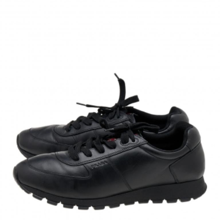 Coming in a classic low-top silhouette, these Prada Sport sneakers are a seamless combination of luxury, comfort, and style. They are made from leather in a black shade. These sneakers are designed with logo details, laced-up vamps, and comfortable