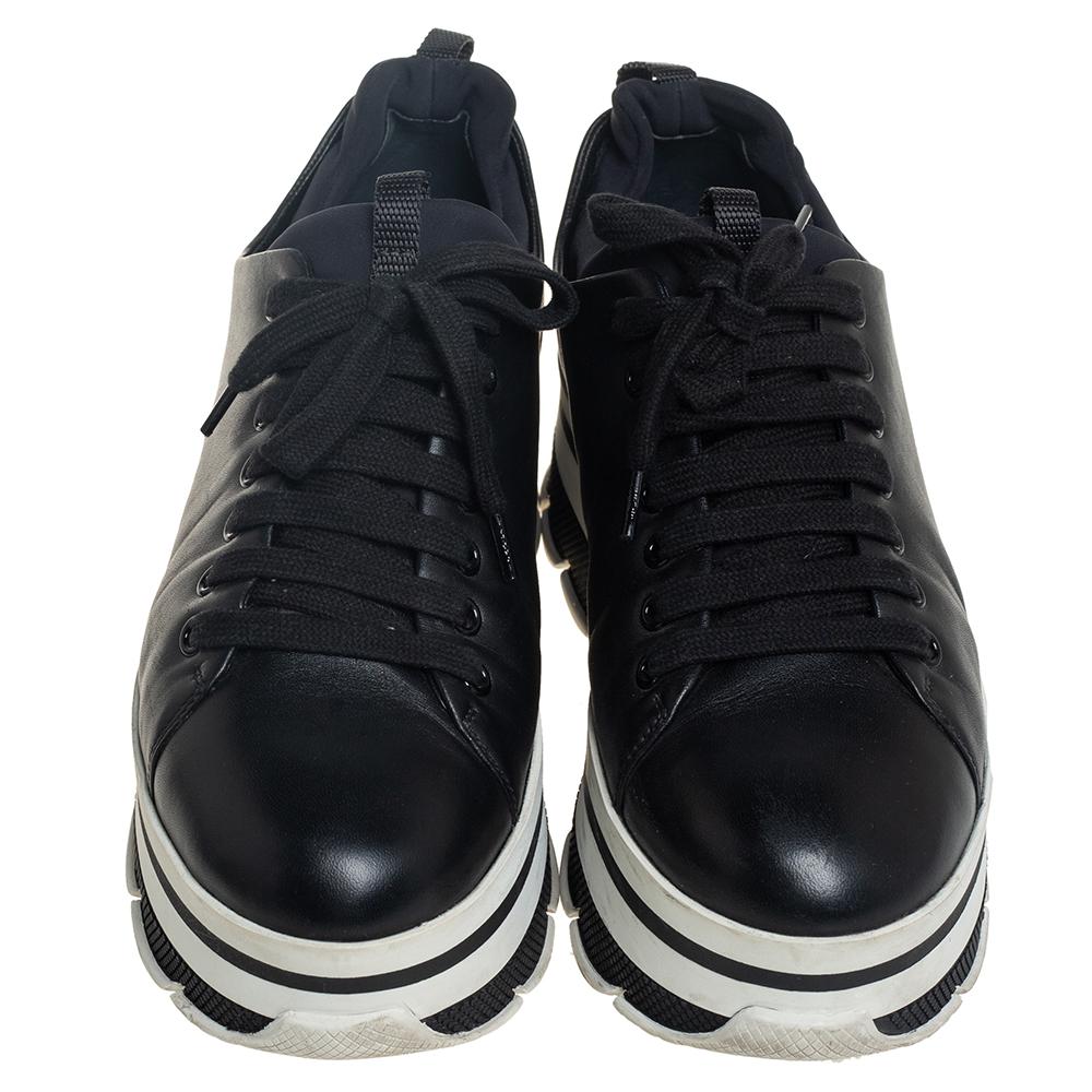 Project a stylish look every time you step out in these sneakers from Prada Sport. They are crafted from black leather, styled with lace-ups on the vamps, and elevated on striped platforms. They are equipped with comfortable leather-lined insoles