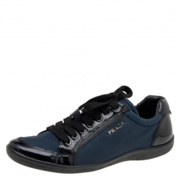 A pair that will see you through a long day in full comfort! Crafted using nylon and patent leather, these Prada Sport sneakers are designed in a low-top style, secured with lace-ups, and set atop durable rubber soles.
