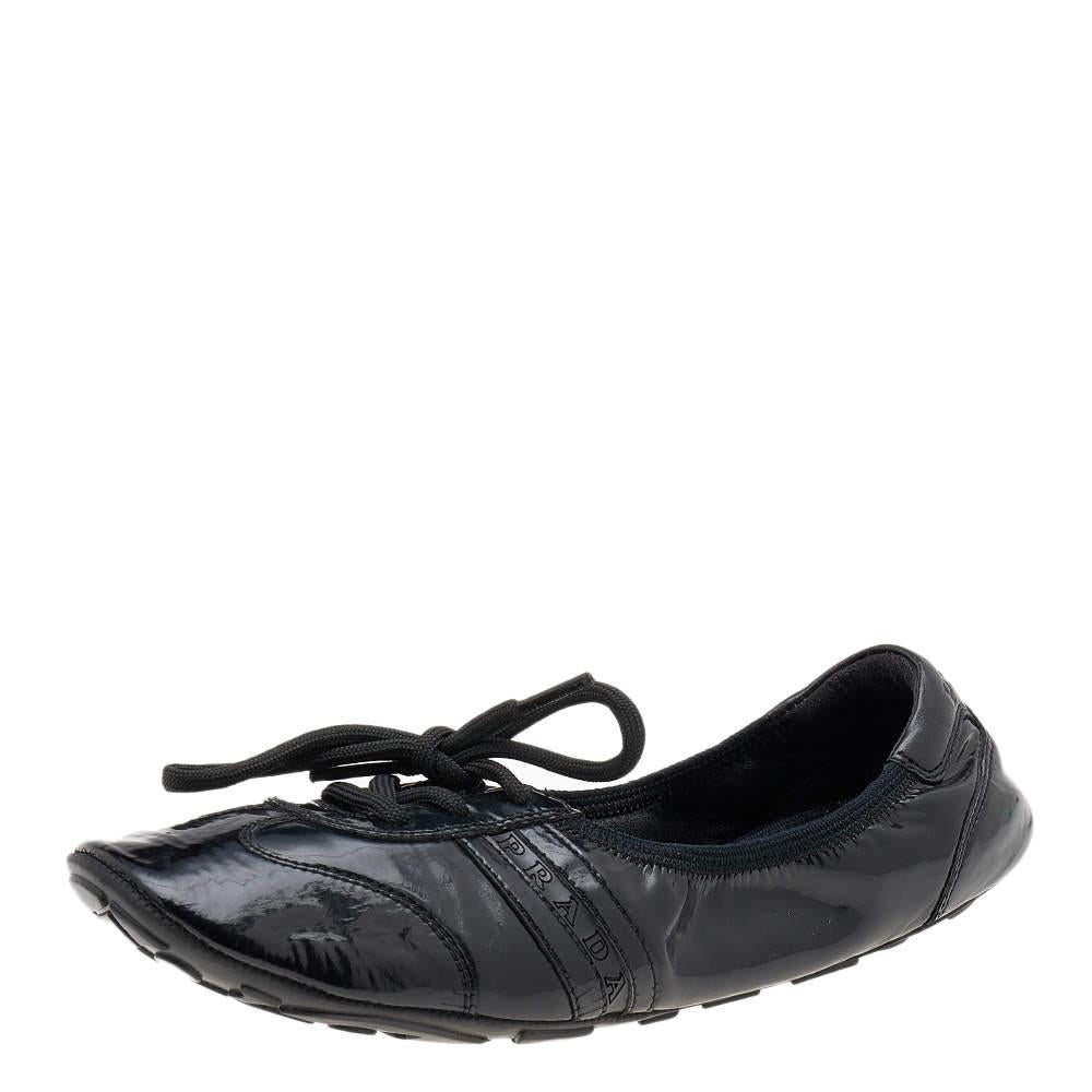 These dainty ballet flats from Prada Sport are all you need in your closet! They are crafted from black patent leather and have lace-ups as well as durable rubber soles for a comfortable fit. 