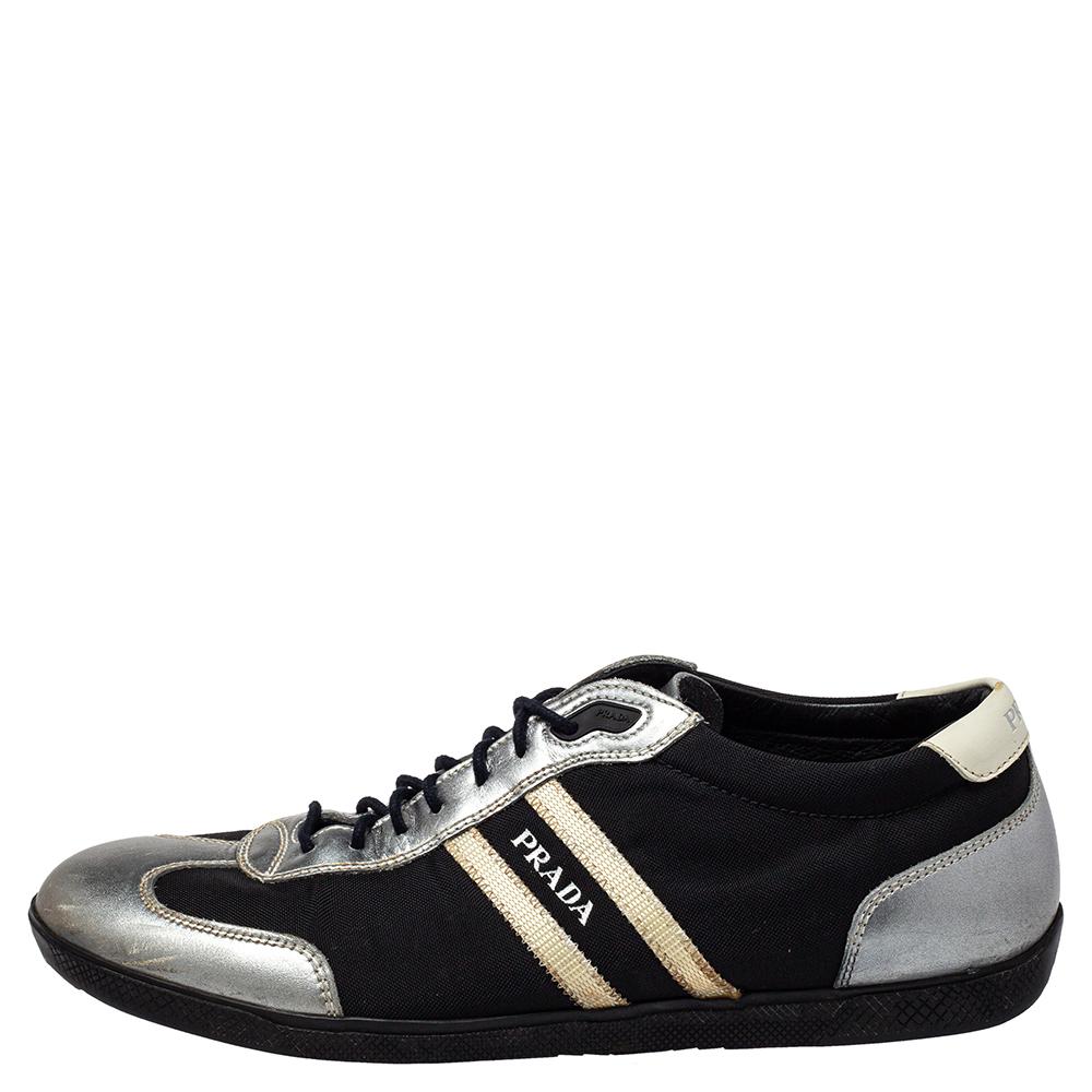 Fashioned in a low-top silhouette, these Prada Sport sneakers feature a silver laminated leather and black nylon body and come with round toes. Completed with lace-ups and logo details on the sides and the counters, this pair is set on rubber soles