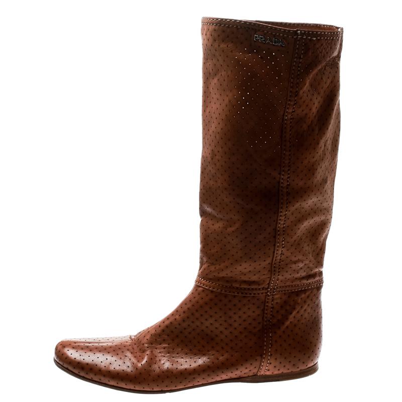 Chic, smart and stylish, these mid-calf boots from Prada Sport deserve a special place in your wardrobe! The brown boots are crafted from perforated leather and feature round toes. They flaunt a silver-tone brand logo detailing on the top and come