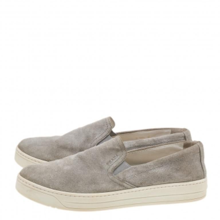 The House of Prada brings you these slip-on sneakers to elevate your appearance and grant your feet comfort! They are crafted using grey suede on the exterior. Walk with style and confidence in these sneakers!