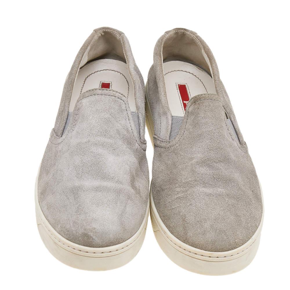 The House of Prada brings you these slip-on sneakers to elevate your appearance and grant your feet comfort! They are crafted using grey suede on the exterior. Walk with style and confidence in these sneakers!

