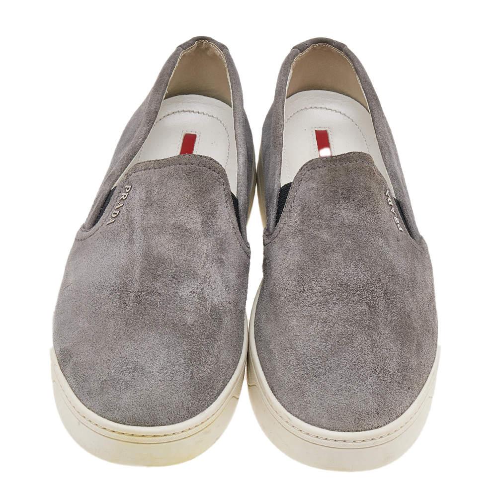 The House of Prada brings you these slip-on sneakers to elevate your appearance and grant your feet comfort! They are crafted using grey suede on the exterior. They flaunt a gunmetal-tone logo accent on the vamps. Walk with style and confidence in