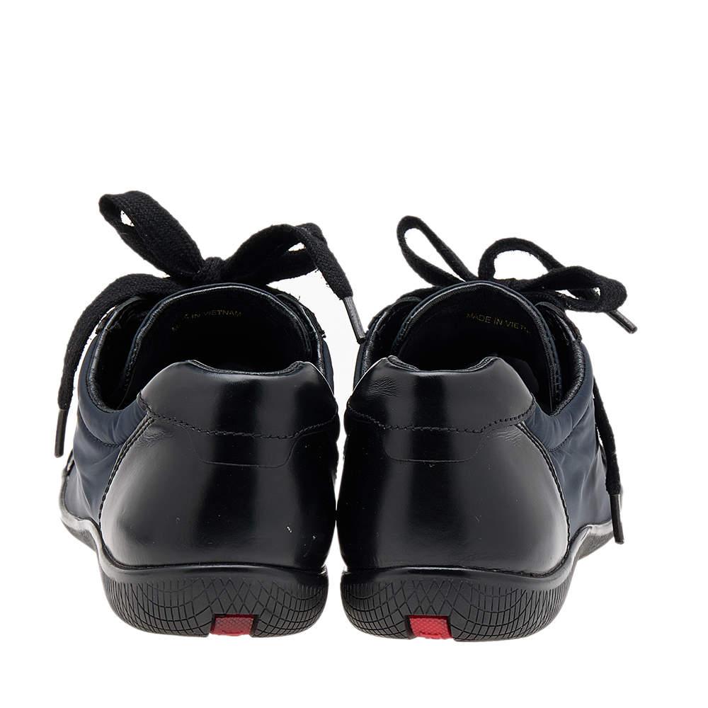 Prada Sport brings you these super stylish sneakers to elevate your appearance! They are crafted using black and navy-blue nylon and leather into a sturdy low-top silhouette. They exhibit lace-up fastenings and silver-tone hardware. Walk with style