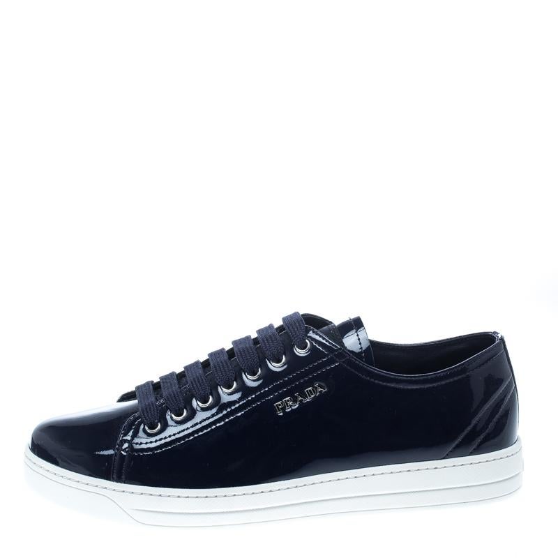The clean-cut and glossy look of these sneakers from Prada Sport is created with the navy blue patent leather exterior, finished off with matching lace-up front and brand detailing on the sides. These are a perfect pair to dress up or down for your