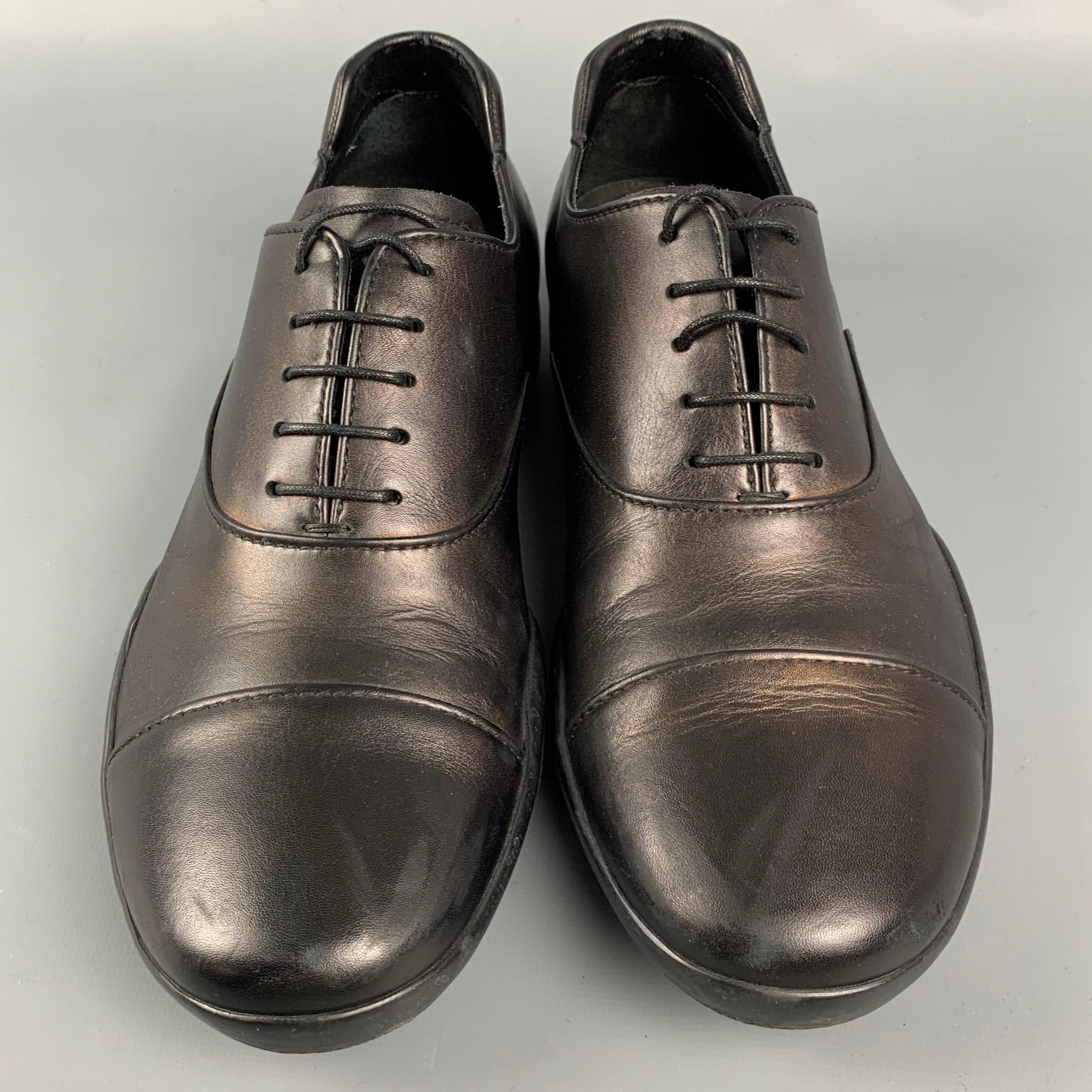 PRADA SPORT shoes comes in a black leather featuring a cap toe. rubber sole, and a lace up closure. 

Very Good Pre-Owned Condition.
Marked: 4 E 0770 5.5

Outsole: 10.5 in. x 4 in. 